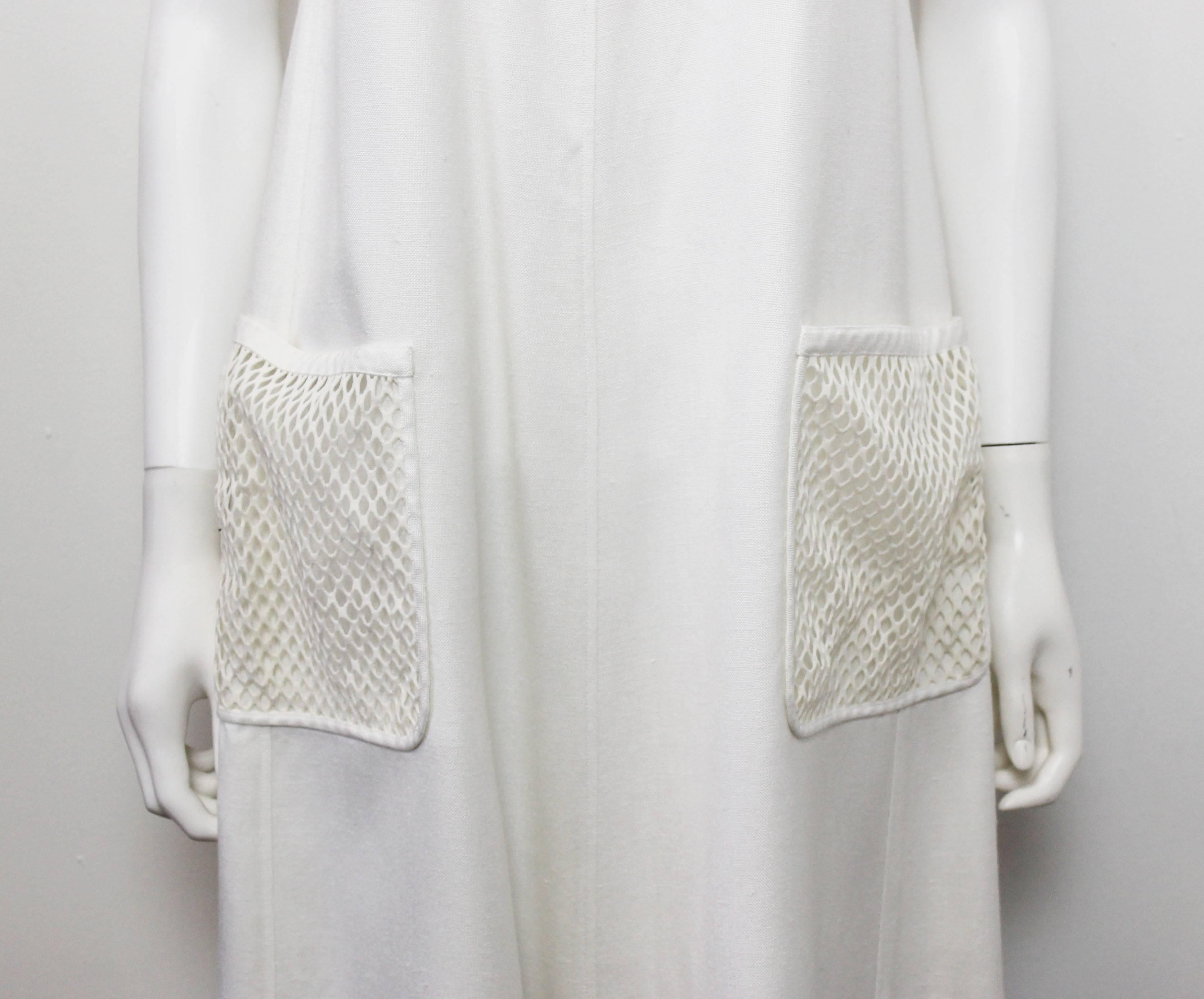 A classic and timeless piece by Courreges. The dress features an a-line shape with white net pockets and back panel.
