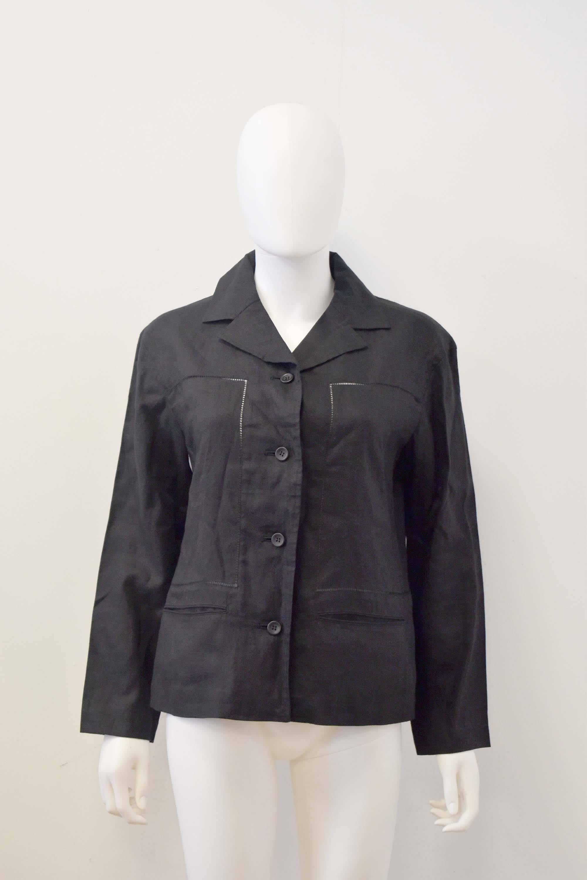 Black linen jacket from Issey Miyake’s mainline collection. The jacket has a cropped, boxy shape with a notched collar, button fastenings and two pockets at the hip. The jacket has fagotted panels along the front and centre back seam. The jacket is