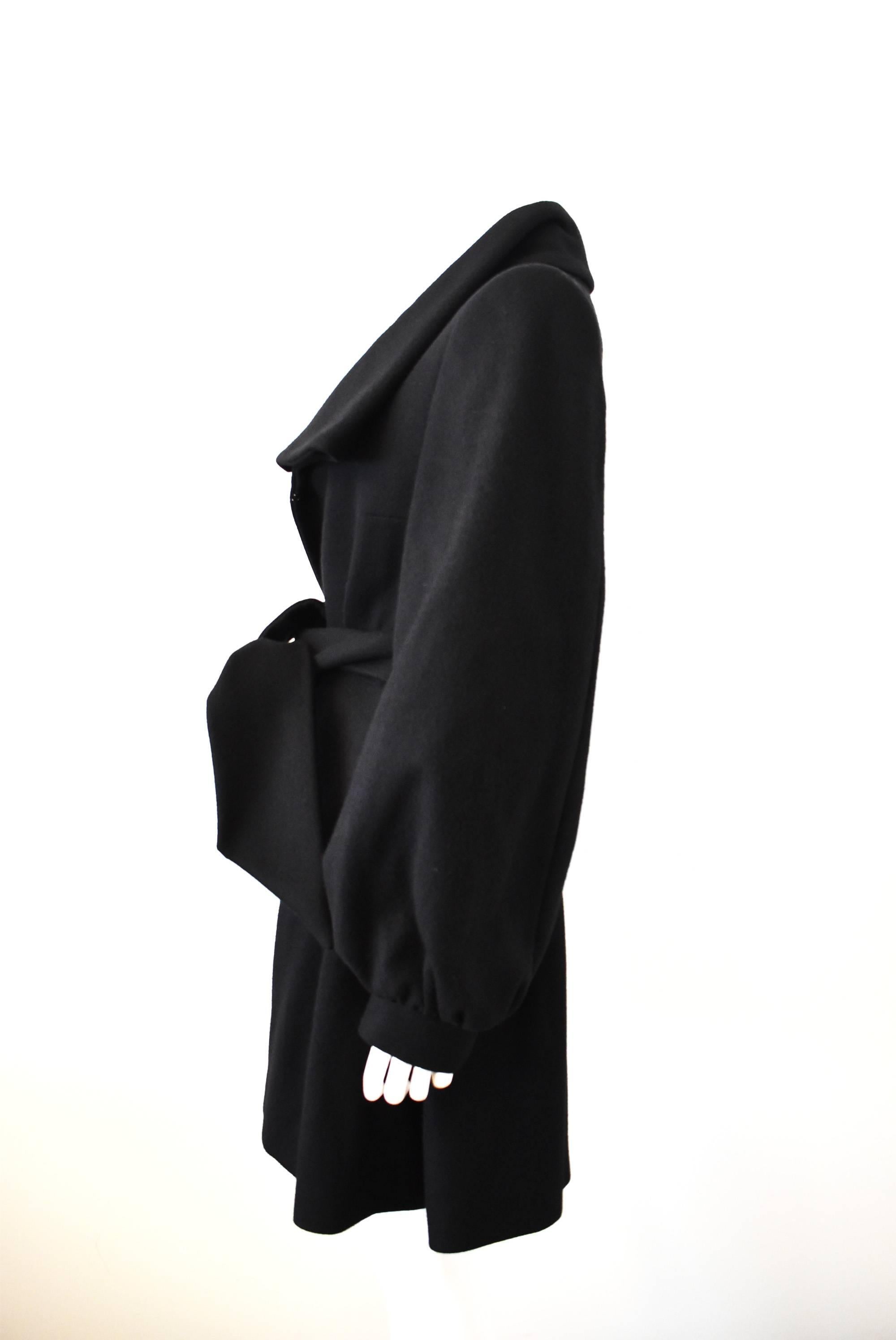 A luxurious and super soft cashmere and wool black coat from Stella McCartney. The coat has a large collar, open from and belt-tie fastening at the waist. This creates an hourglass silhouette on the wearer, drawing in the waist. It also has