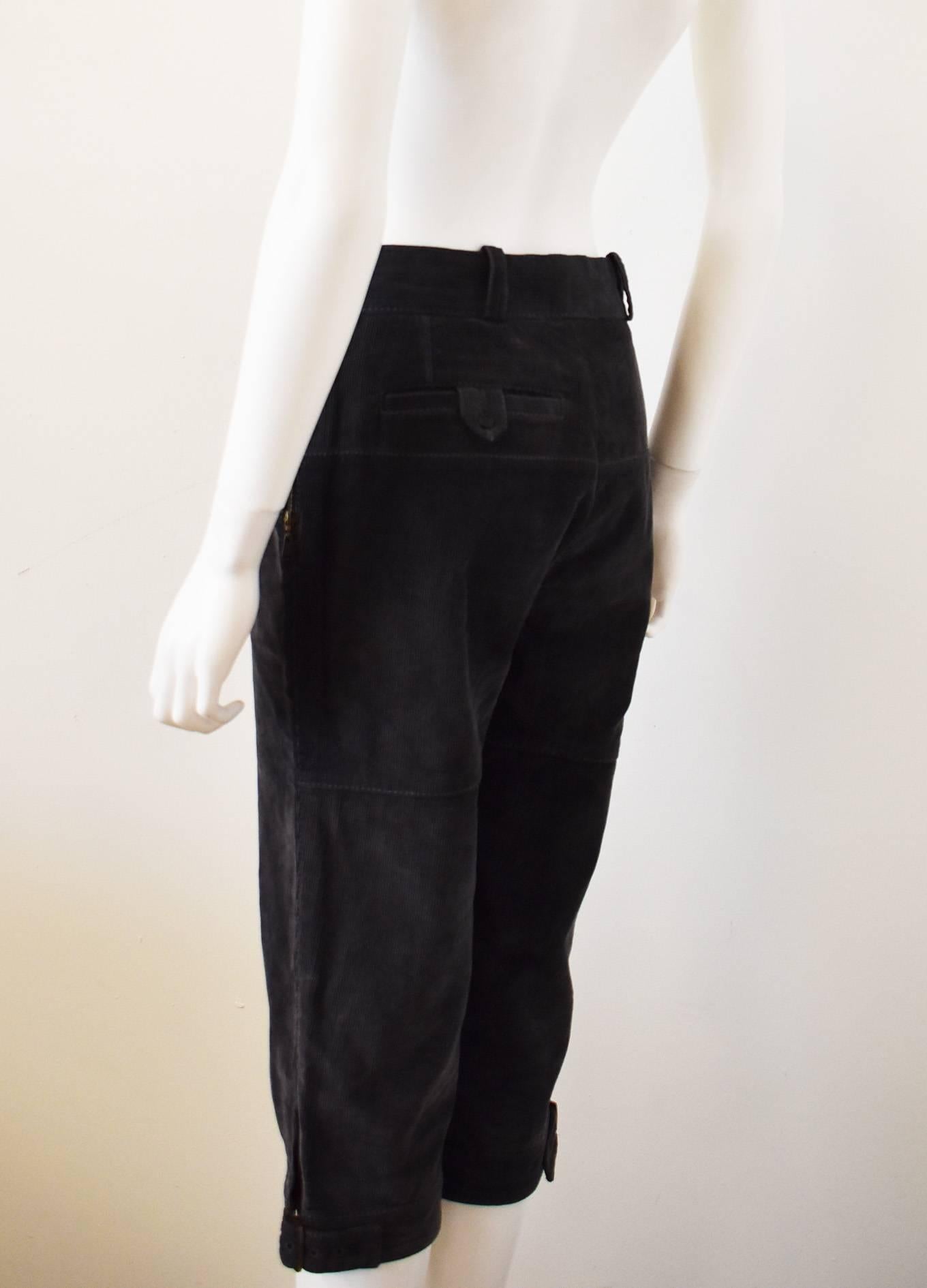 A pair of charcoal grey corduroy plus fours by Louis Vuitton. The cropped trousers have a simple straight shape with hook fastening at the waist and buckles at the cuffs to tighten or loosen the leg holes. The trousers have contrast white stitching