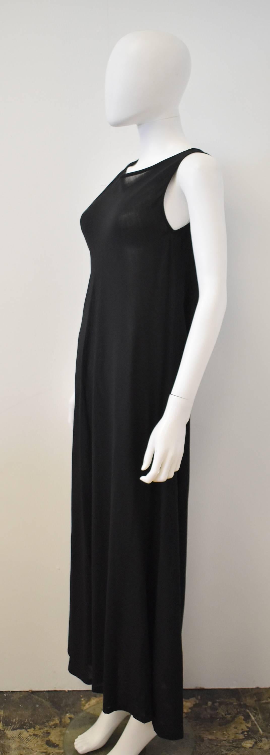 A beautiful semi-sheer dress from Y’s by Yohji Yamamoto. The sleeveless dress is ankle length with a simple A-line shape that is cut on the bias creating a skirt that falls with soft folds and has great movement. The material is a thin wool blend