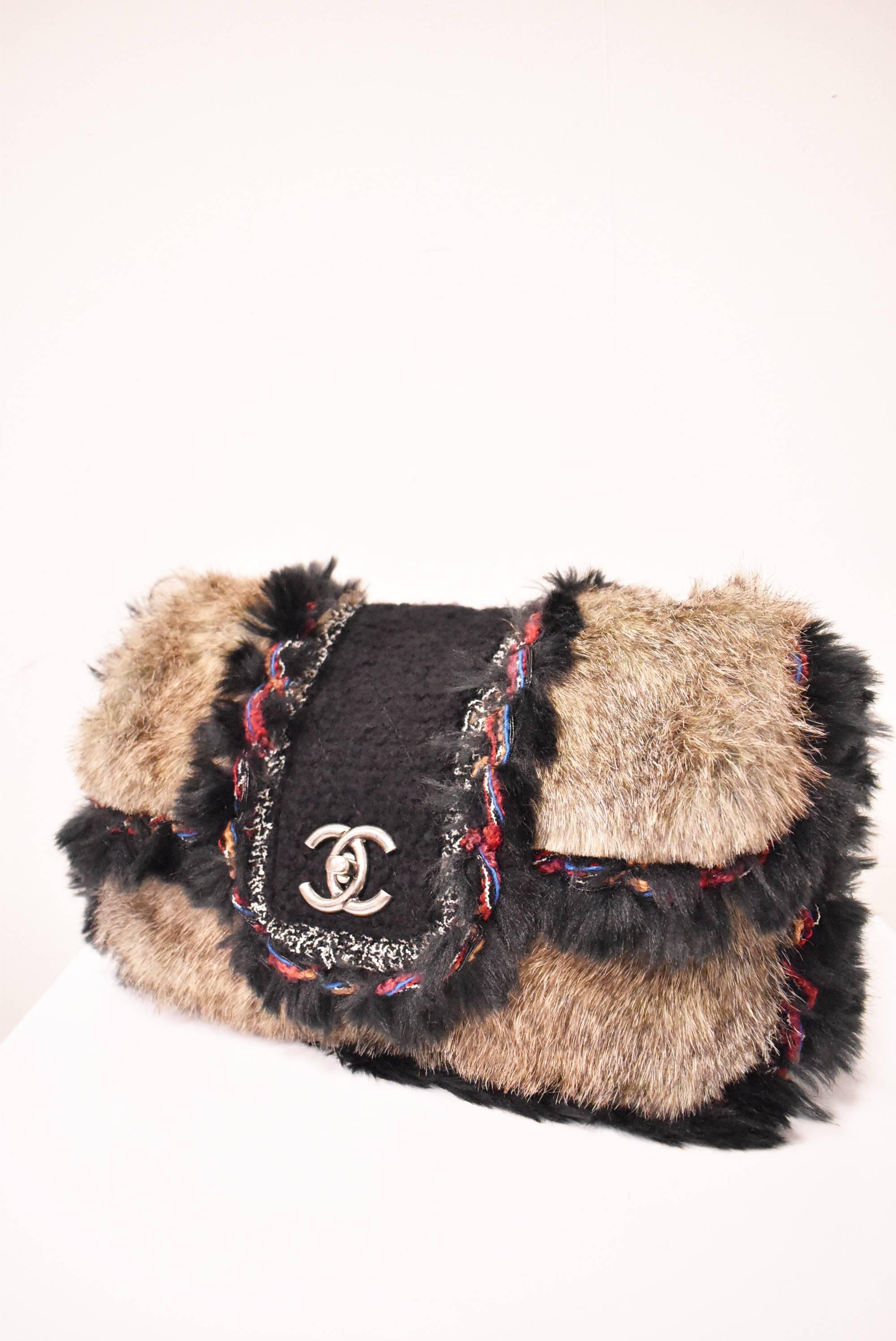 A faux fur and tweed handbag from the Autumn/Winter 2010 Chanel Ready To Wear collection. The bag is a classic two-handle, rectangular bag with a fold-over opening. The clasp has a twist opening featuring the Chanel 'CC' monogram. Th bag is made of