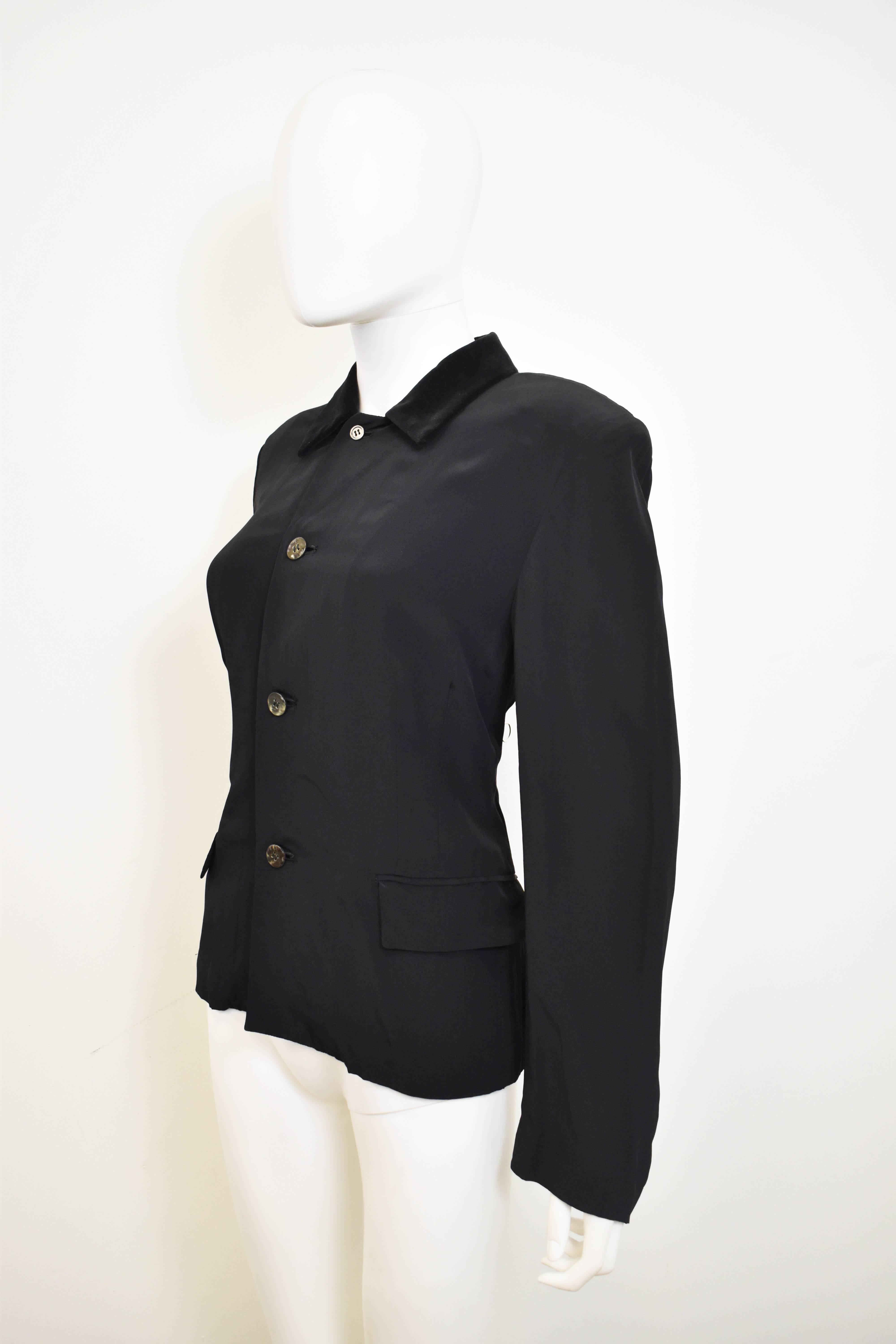 A black fitted shirt with contrast velvet collar from Comme des Garcons’ diffusion line Robe de Chambre. The shirt has a jacket-like design with a slim shape, a fitted waist, light padding in the shoulders, pockets at the waist and slight flare to