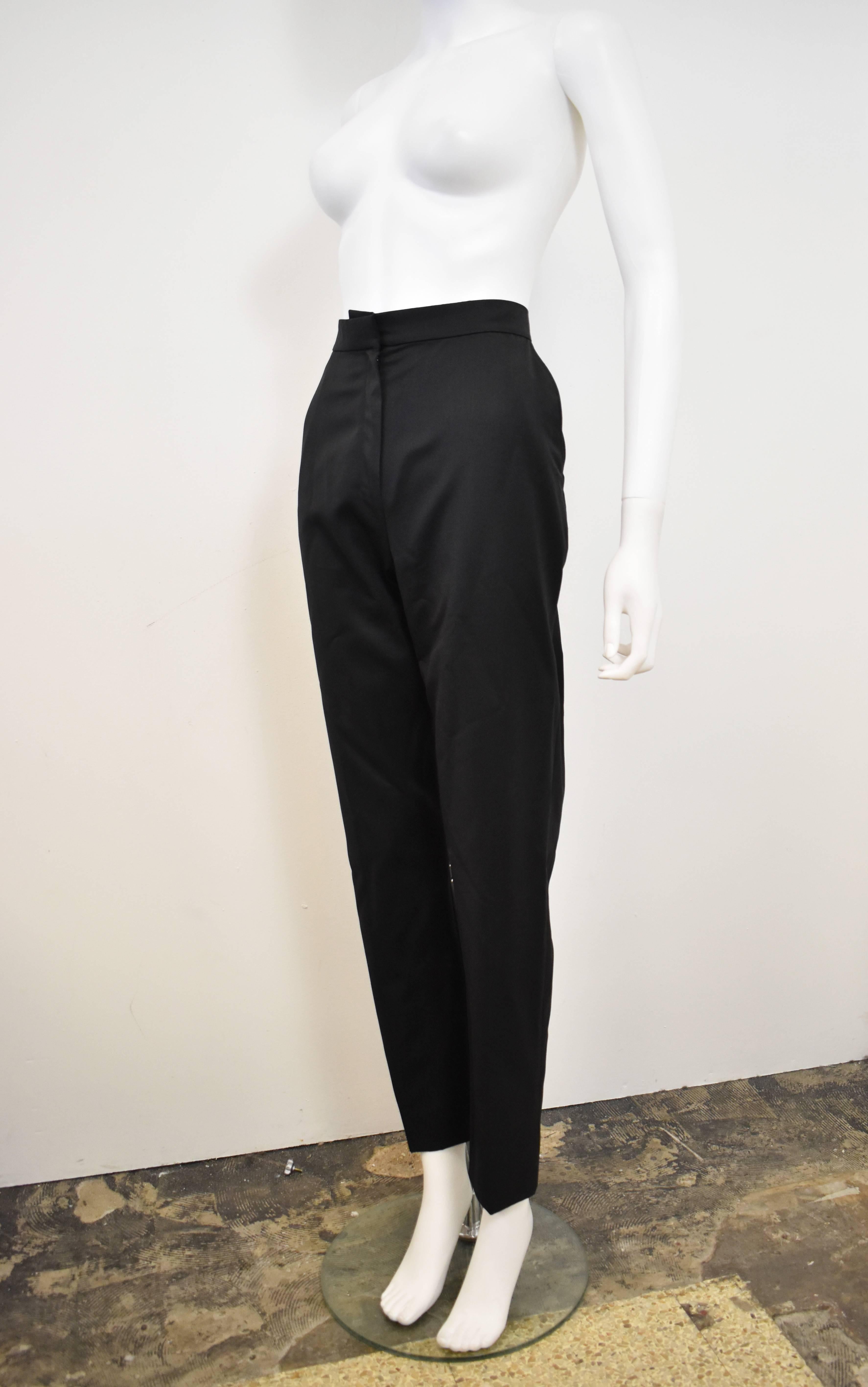 A pair of classic, vintage Yves Saint Laurent Rive Gauche Black Tuxedo Trousers. They have a wonderful Cigarette Pant shape with high-waist, slim fit and tapered legs that gets smaller toward the ankle creating an iconic YSL androgynous,