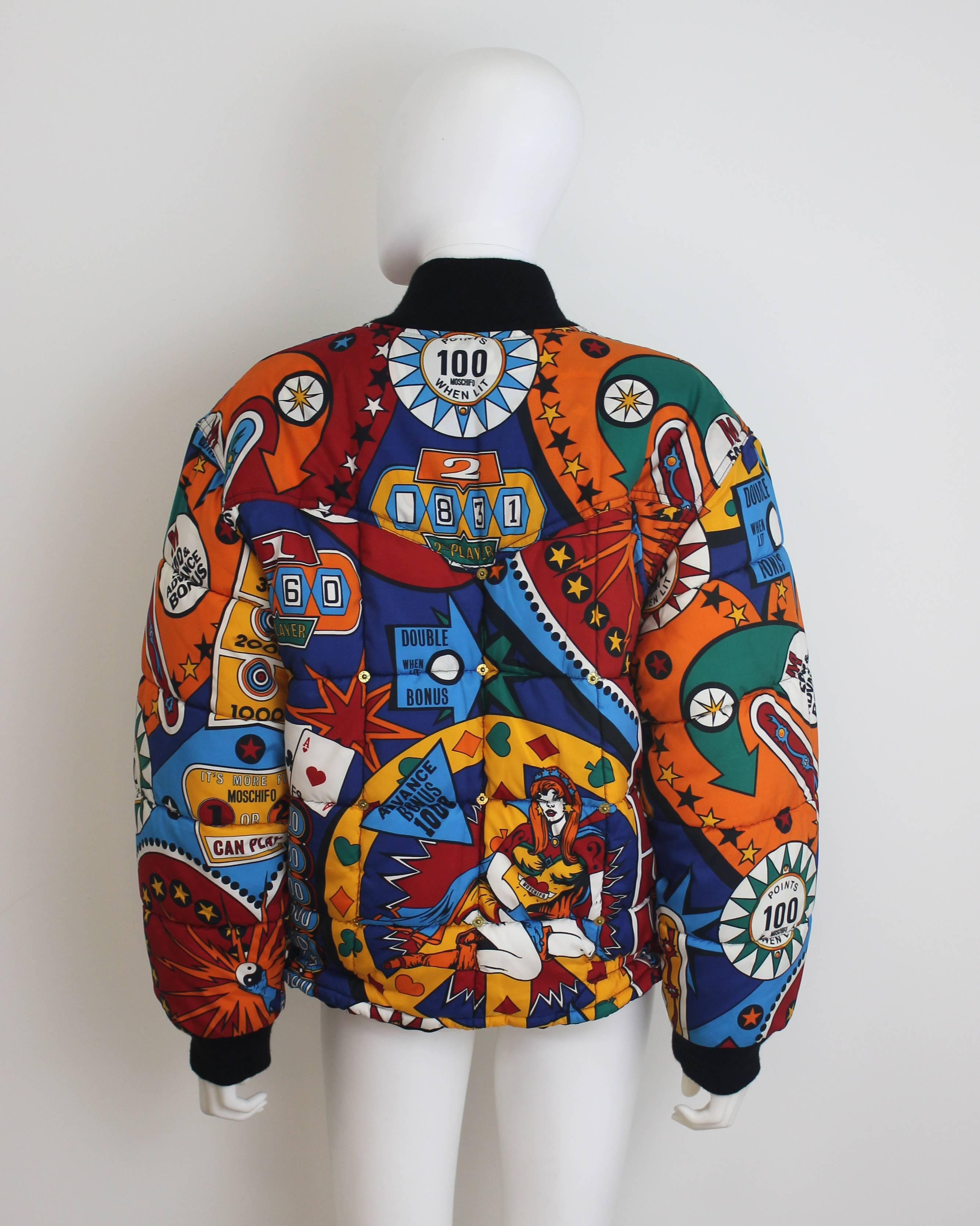 Iconic Moschino Jeans 1990s bomber jacket with a colourful pin-ball print. Features a heart shaped zipper-tab and metal popper details. 