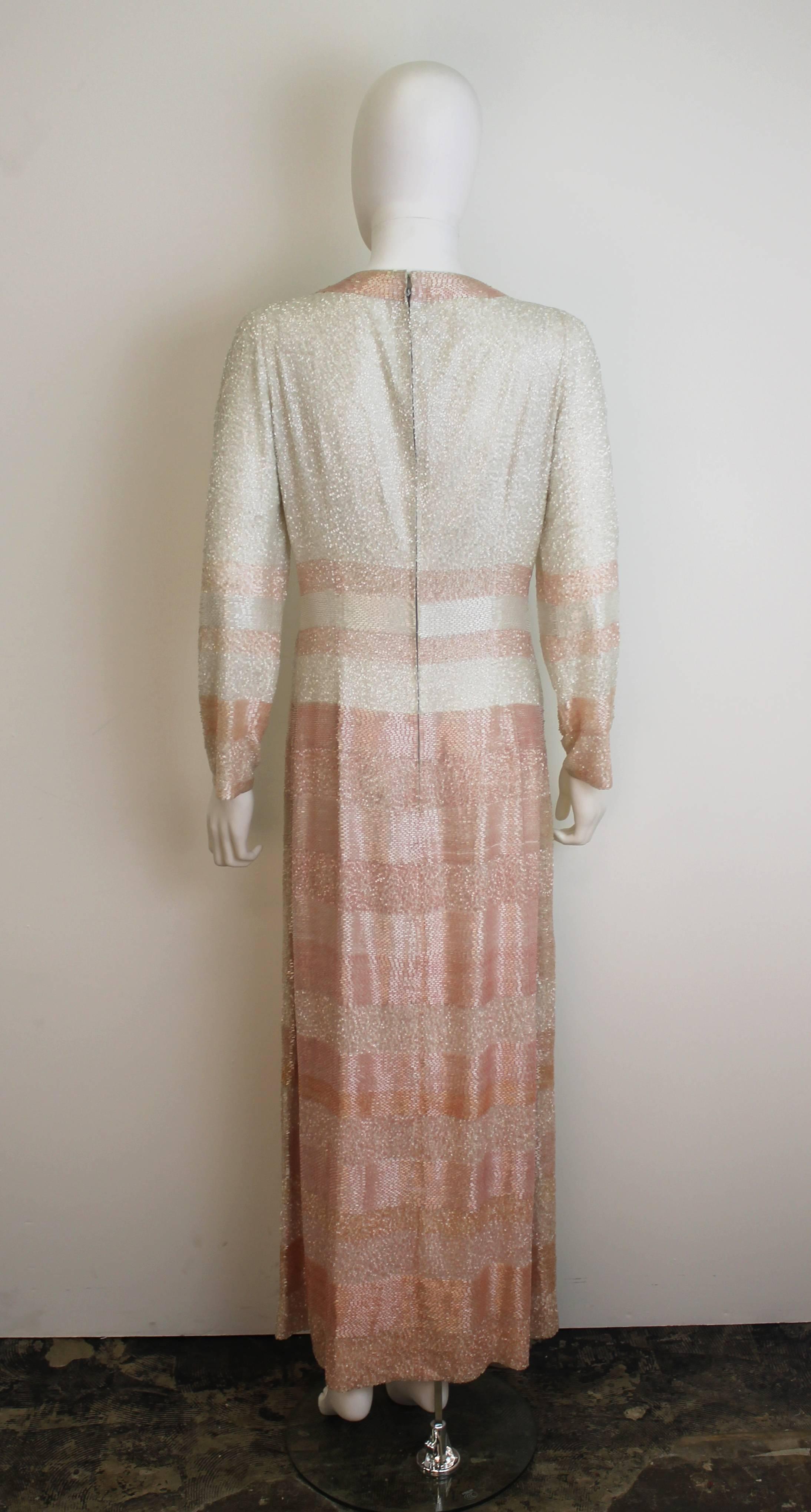 Museum-quality Christian Dior beaded gown from the 1960's. Features pink and white beads of different textures and tie collar. Pattern cutters notes can be seen on interior seems. 