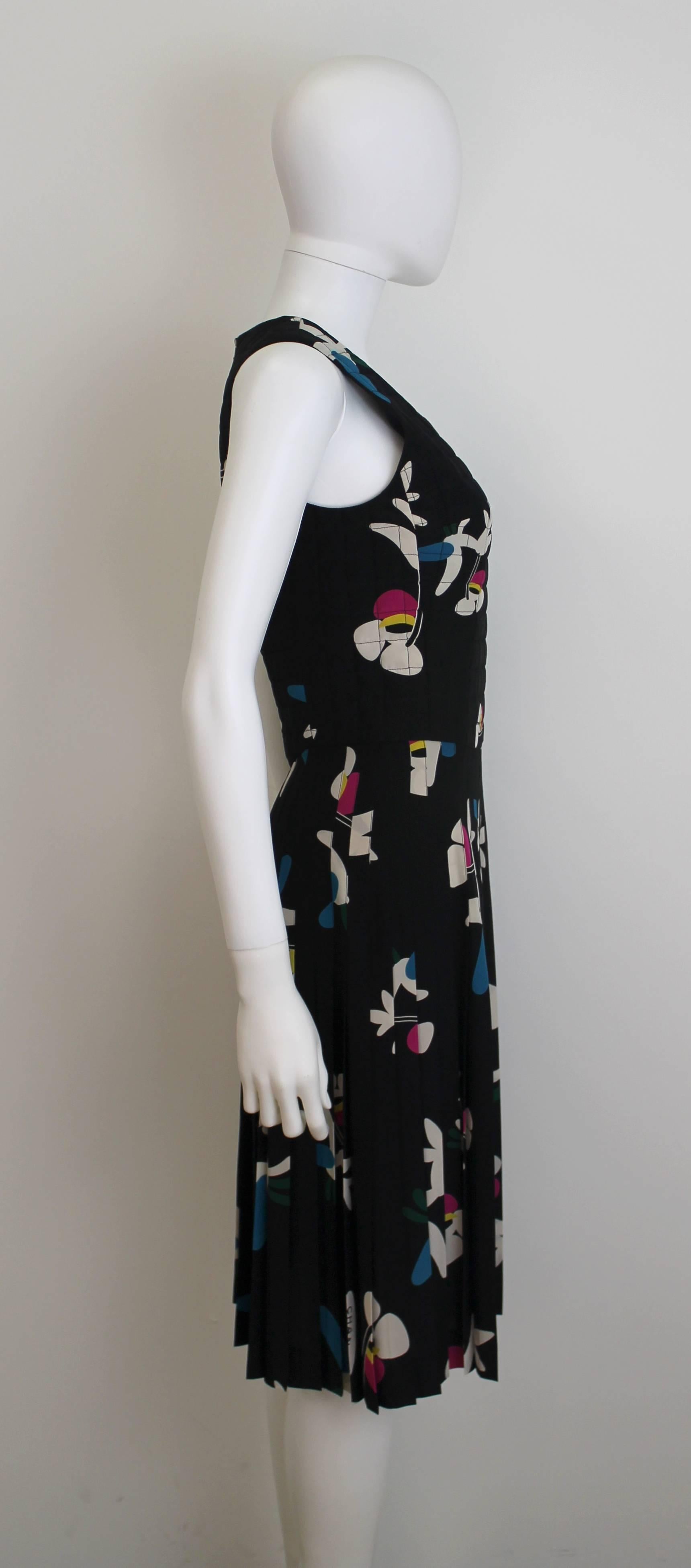 Chanel printed dress from Spring/Summer 2001 with an abstract floral print in pink, white and blue. Features quilted bodice and pleated skirt.
