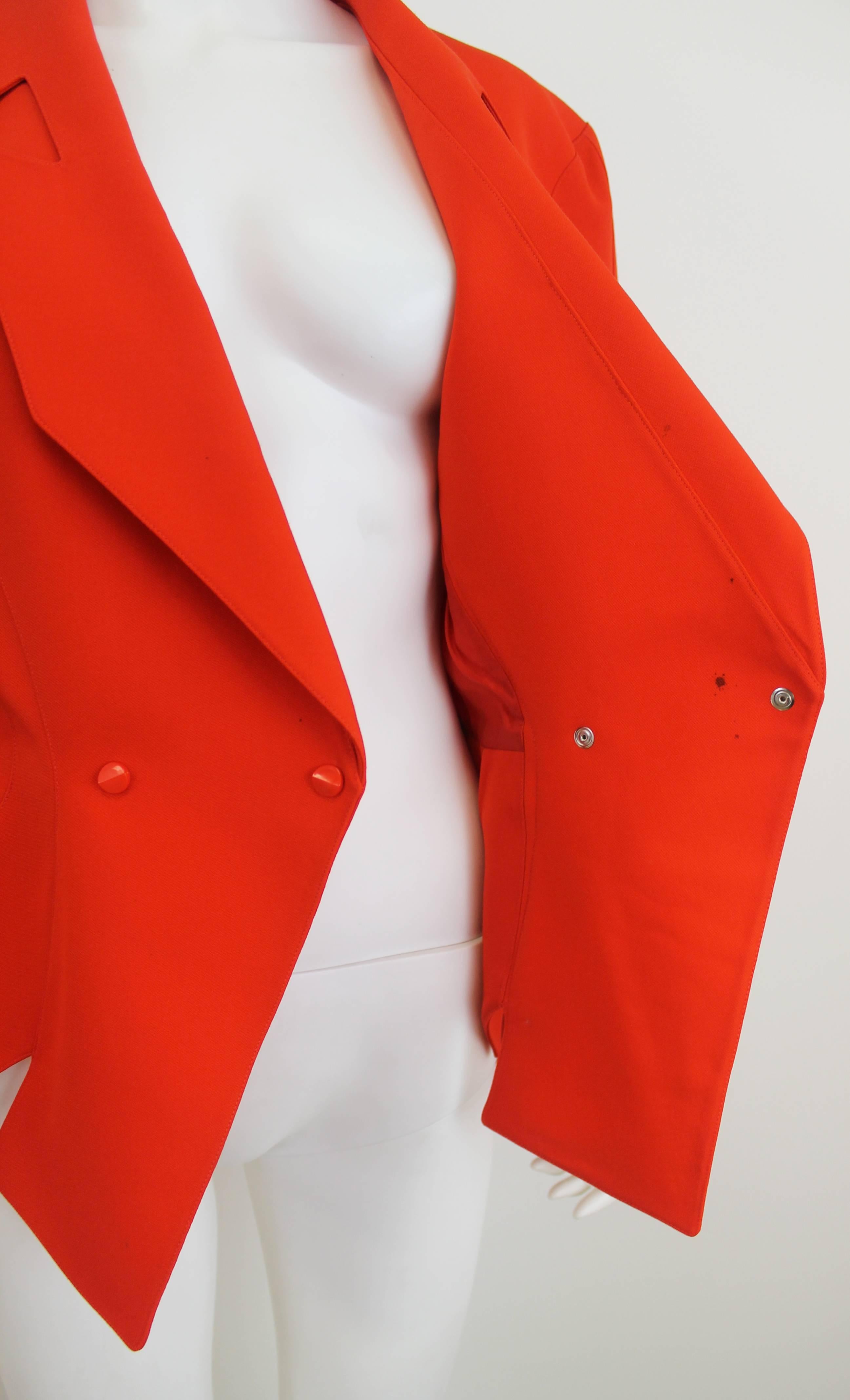 Vintage red Thierry Mugler jacket with M shape cut out on the hem of the jacket and sleeves. Also features cut out detailing along the lapel. 