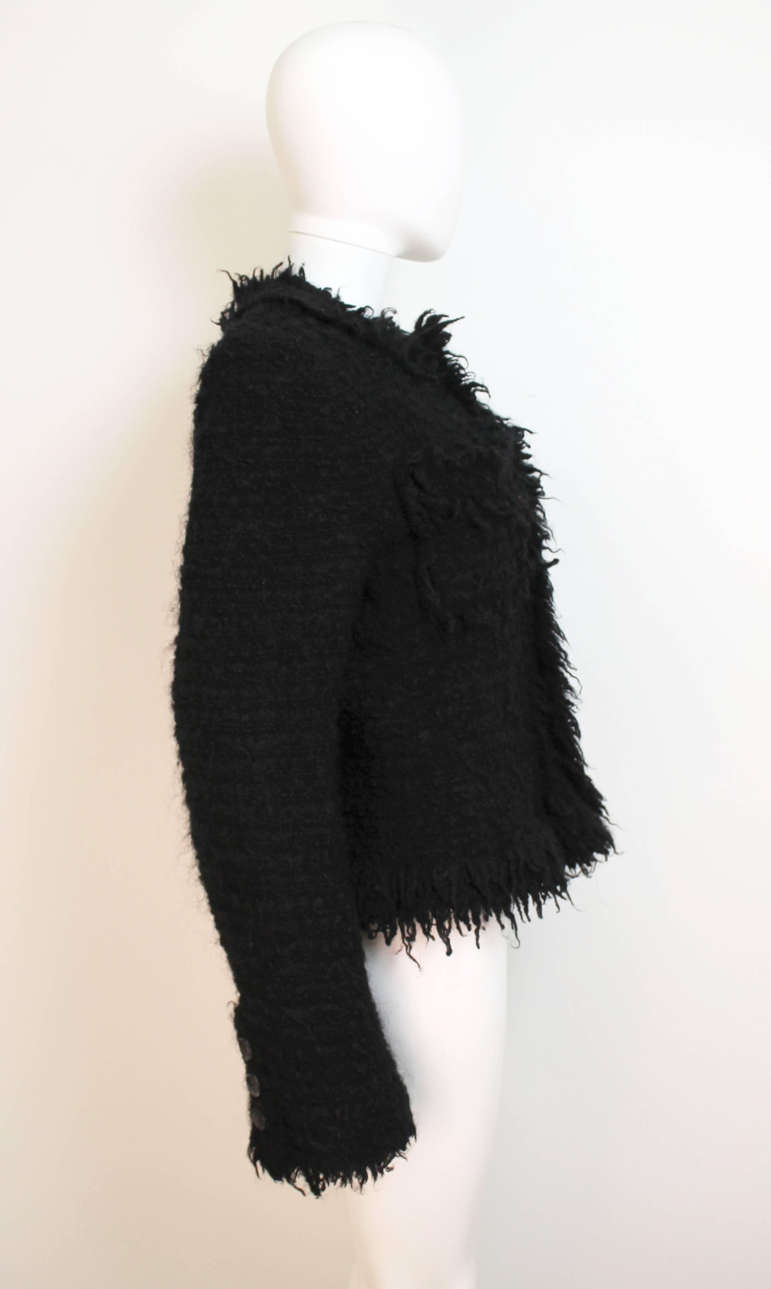 Beautiful black woven jacket with curled and loose yarn leaving the garment raw and unravelling. The piece is from the Fall Winter 2003 collection, which presents the audience with classic fashionable clothing as interpreted by Watanabe.