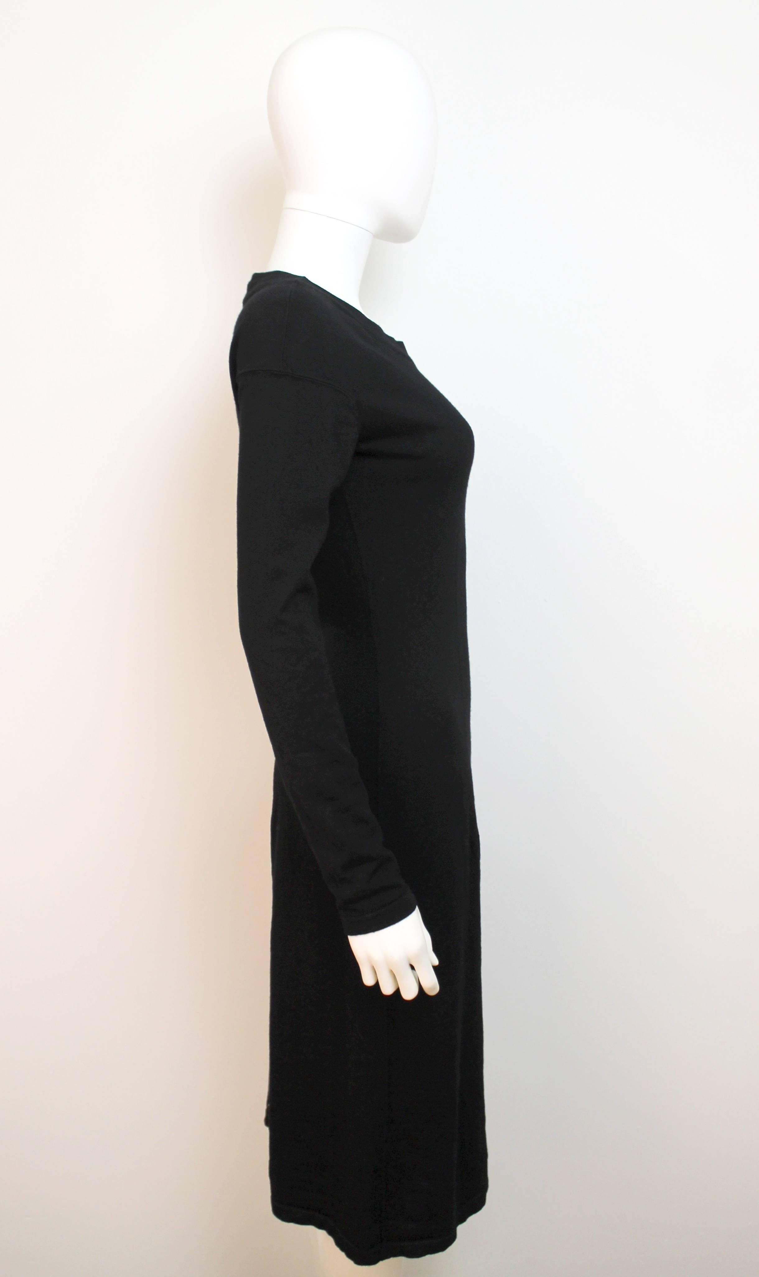 Timeless black mid-length sweater dress with round neck, long sleeves and a figure hugging waist