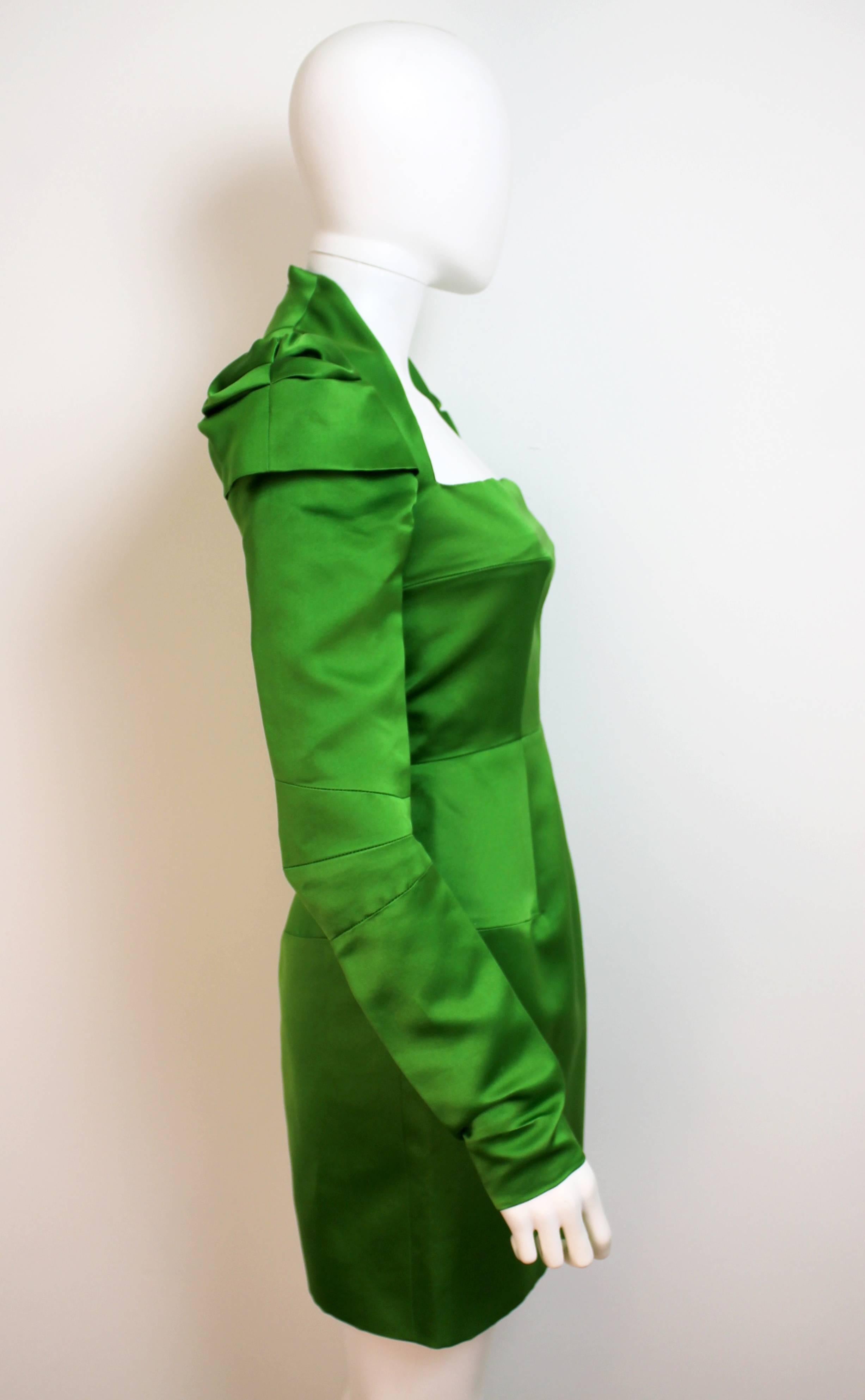 Luxurious bright green dress with bold shoulders and long sleeves. The jewel coloured piece is from the Autumn Winter 2007/08 collection.