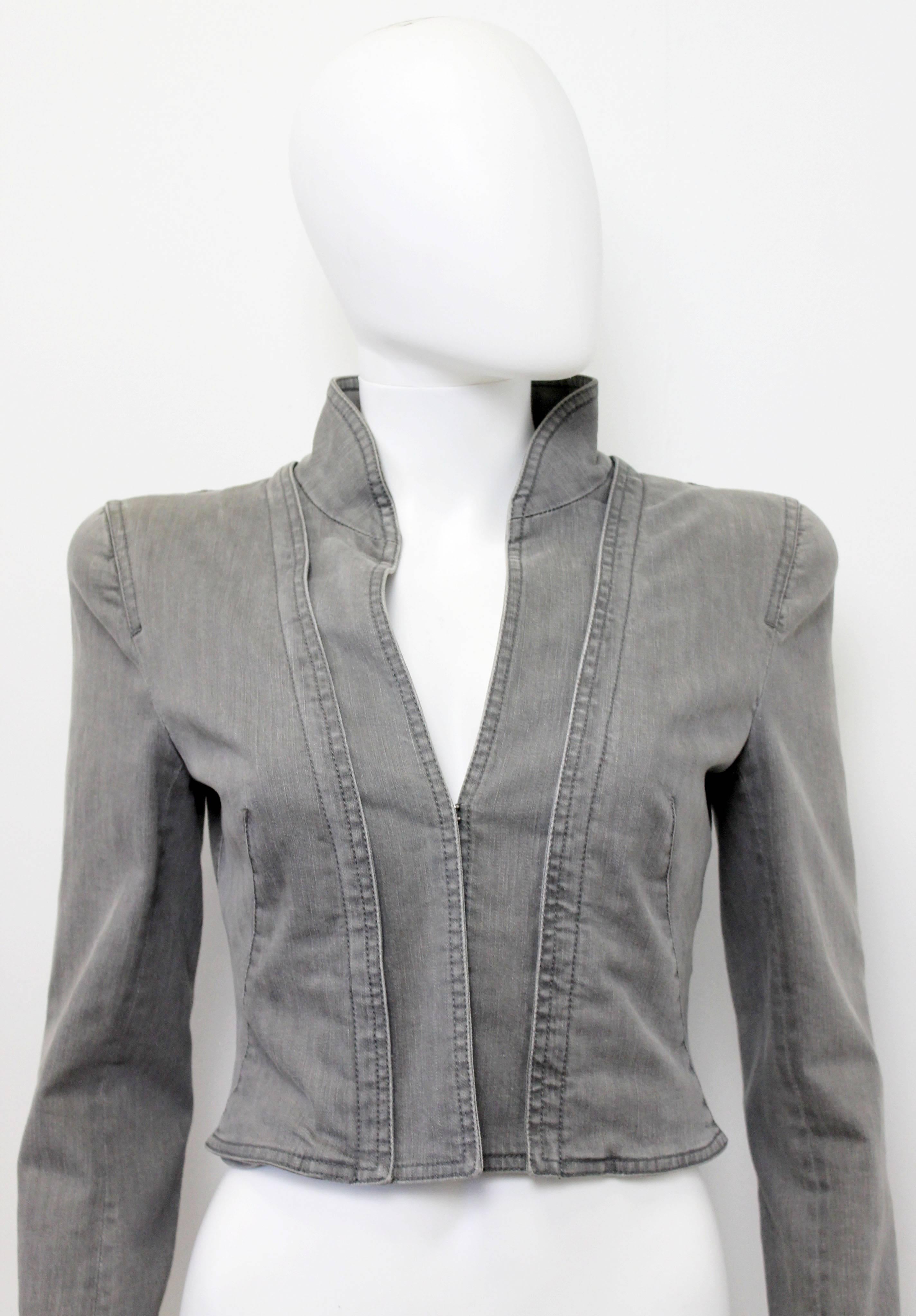 This jacket is a modern take on a riding jacket. The jacket is made from a washed out cotton denim and lined in a fine cotton blend fabric. The structured jacket also features a beautifully padded shoulder, hook and eye closure, unusual diagonal