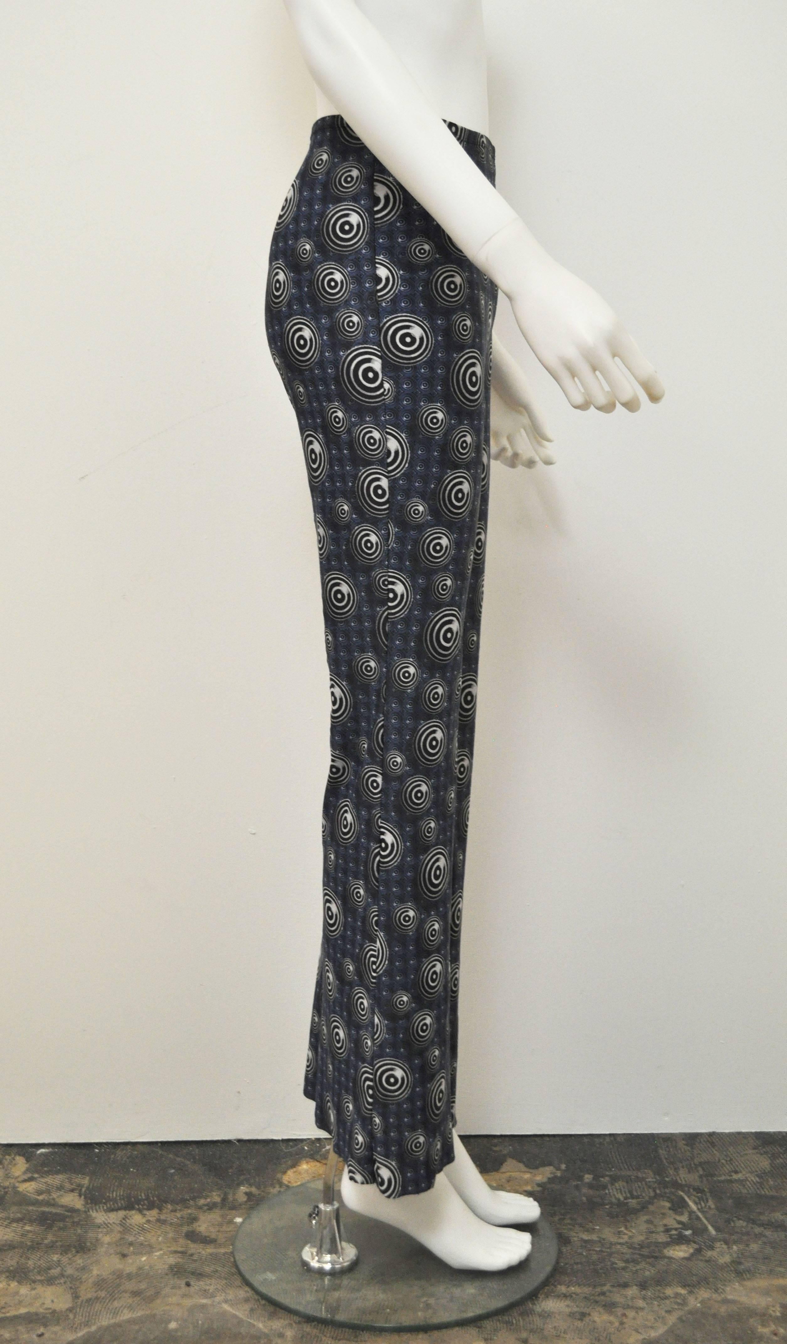 These flared printed trousers date back to the mid 1990.s The jersey trousers are fitted to the top of the leg and then flare out from the knee.The blue geometric pattern is decorated with black and white concentric circles. They feature JPG’s