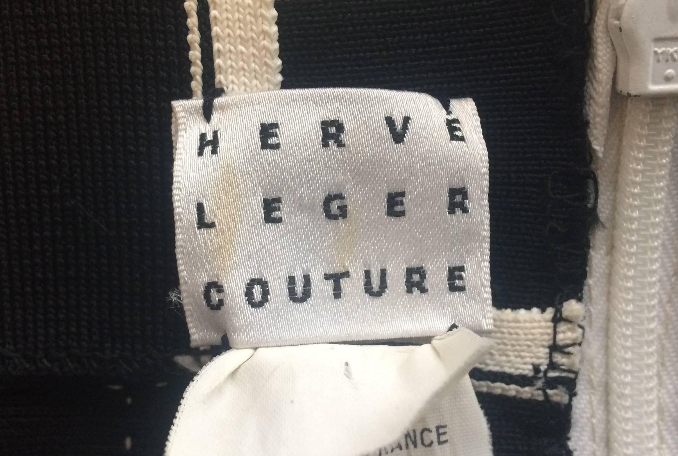 Sexy and seductive black and white bandage dress by iconic designer Herve Leger, popular with celebrities and perfect for a party or night out. The body con dress has a hidden zip in the front and halter neck, supporting the bust and revealing an