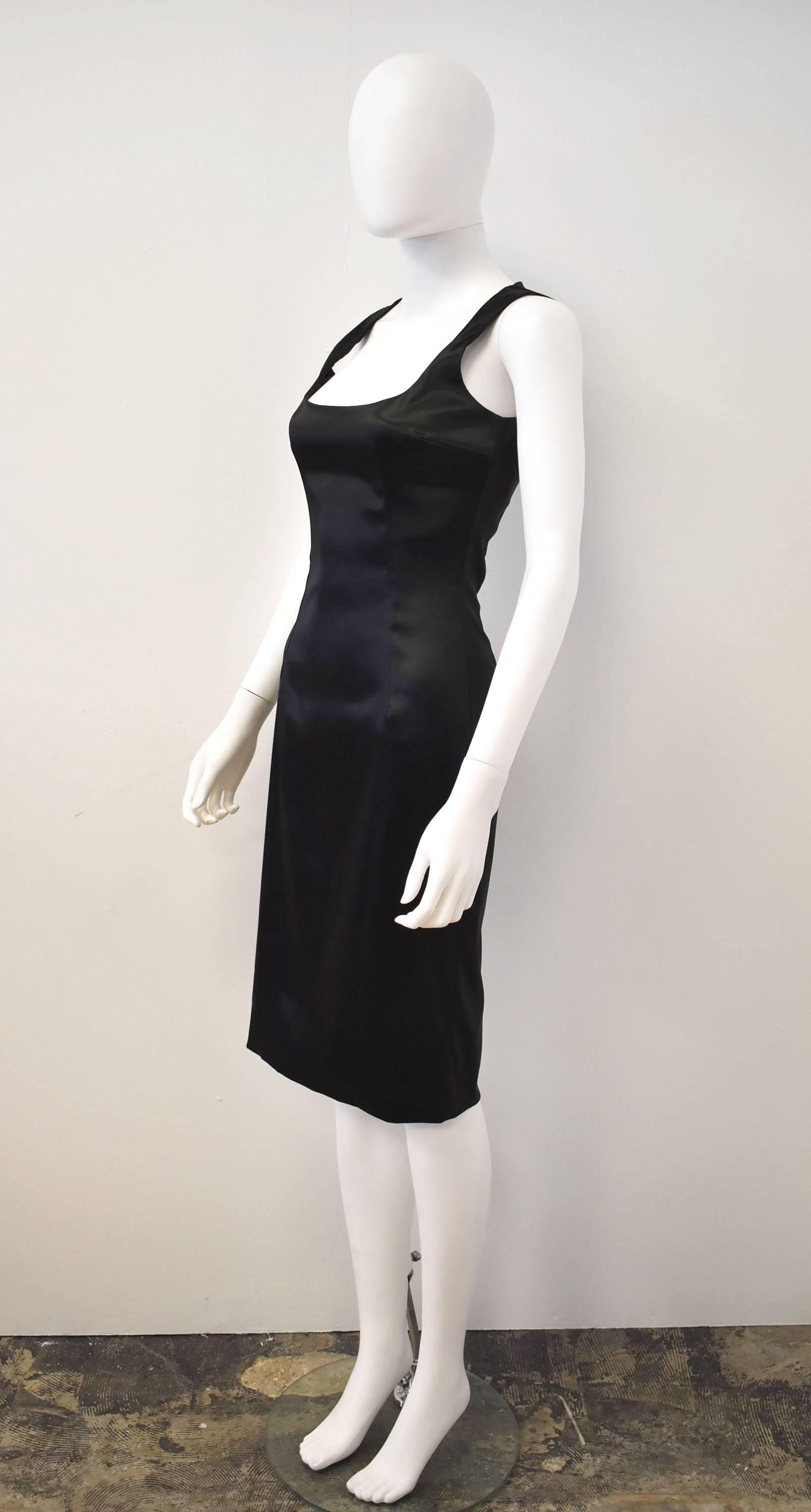Sexy and elegant Little Black Dress by Dolce and Gabbana. The dress is a simple shift dress but it’s form-fitting shape hugs the body and clings to curves. The dress is sleeveless with a zip-fastening at the back and a slit at the back for ease of