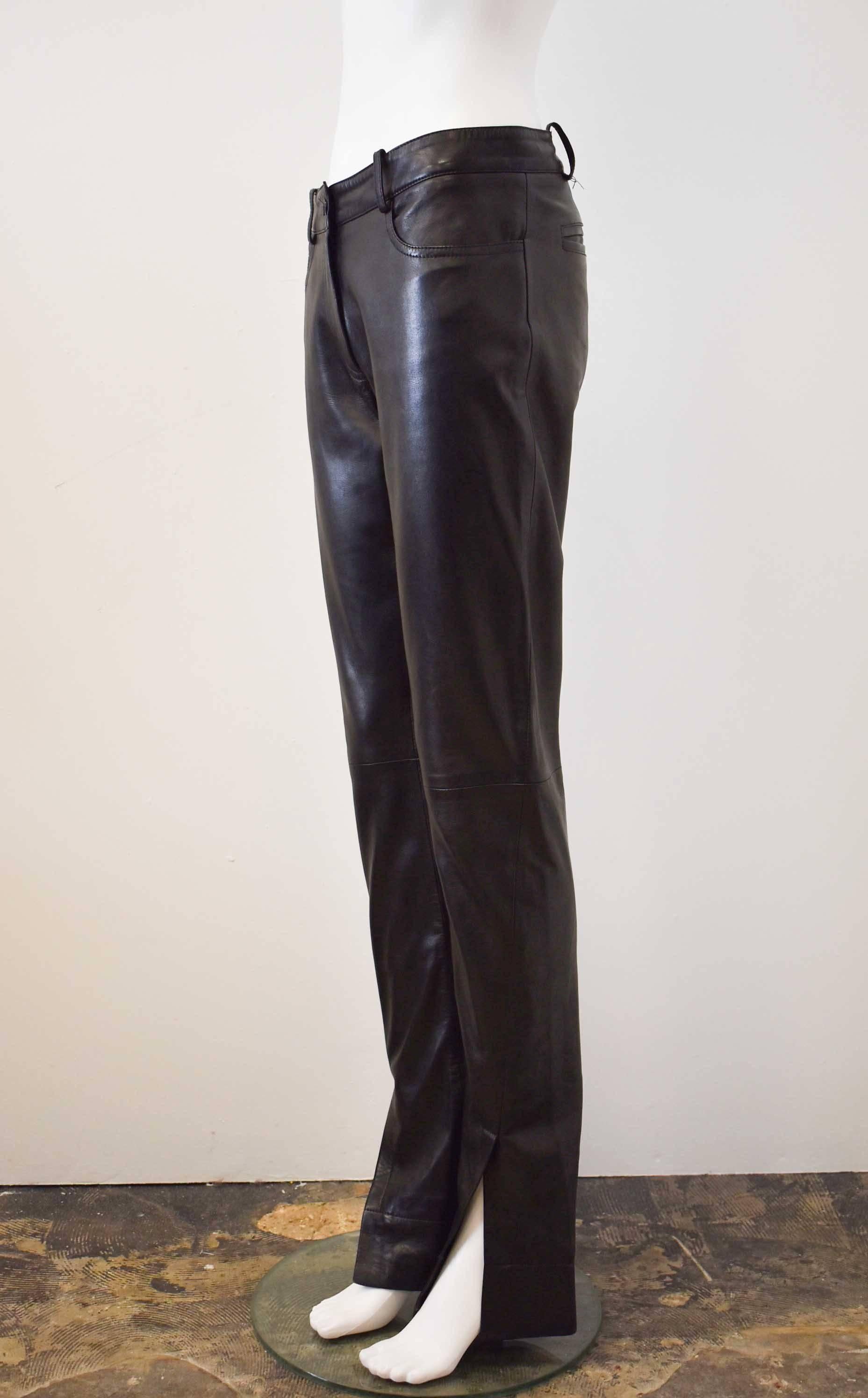 A pair of black, butter-soft leather trousers from Celine. The trousers have a straight, long cut with slits at the cuff, and have a stitch at the knee. They are made from 100% leather and have two pockets at the hip and two at the back.