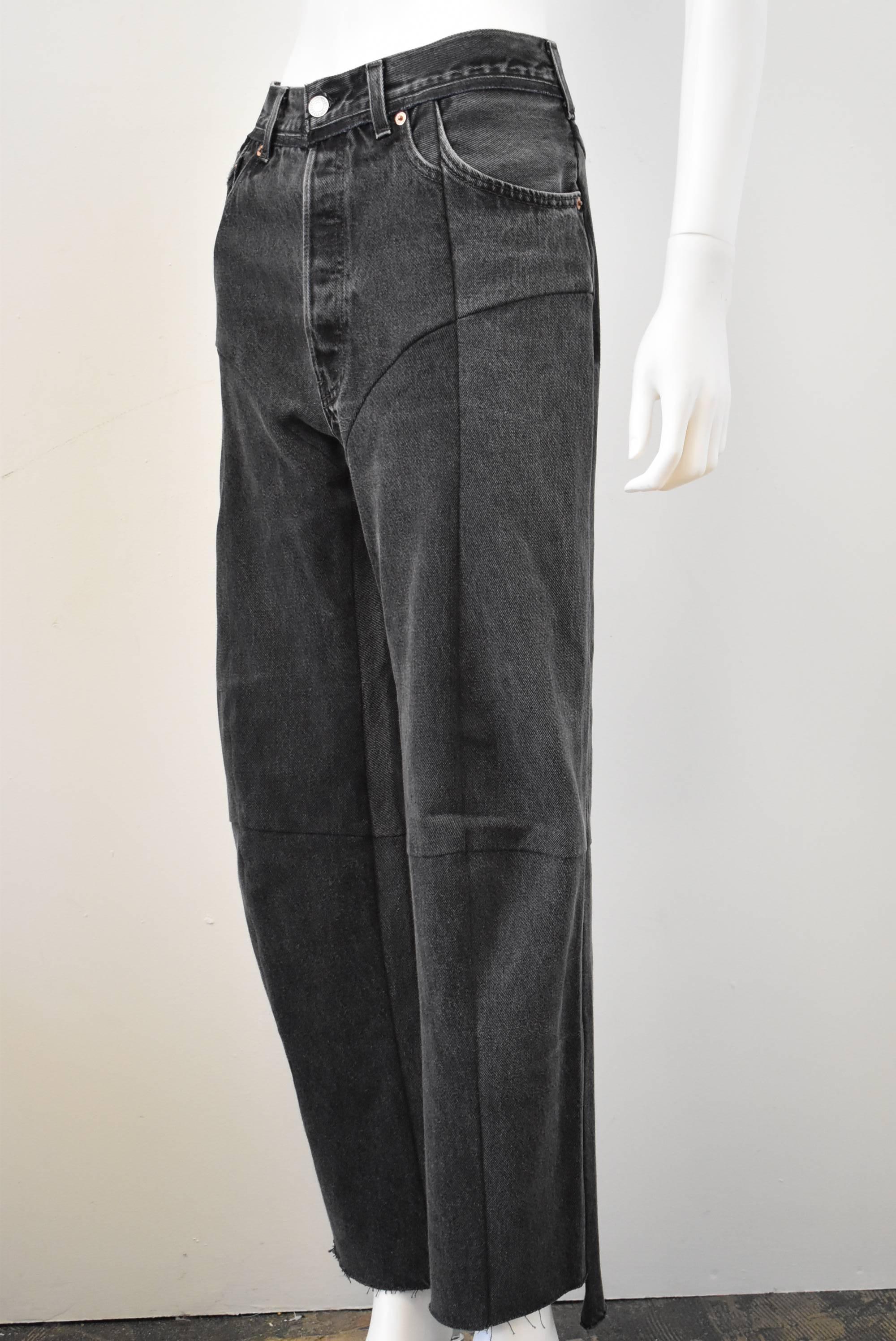 A pair of grey deconstructed jeans from Vetements. The jeans are made from several pairs of reworked Levi’s jeans that are stitched together with seams down the front and at the knee to create these signature denim-wear from the collection. The back