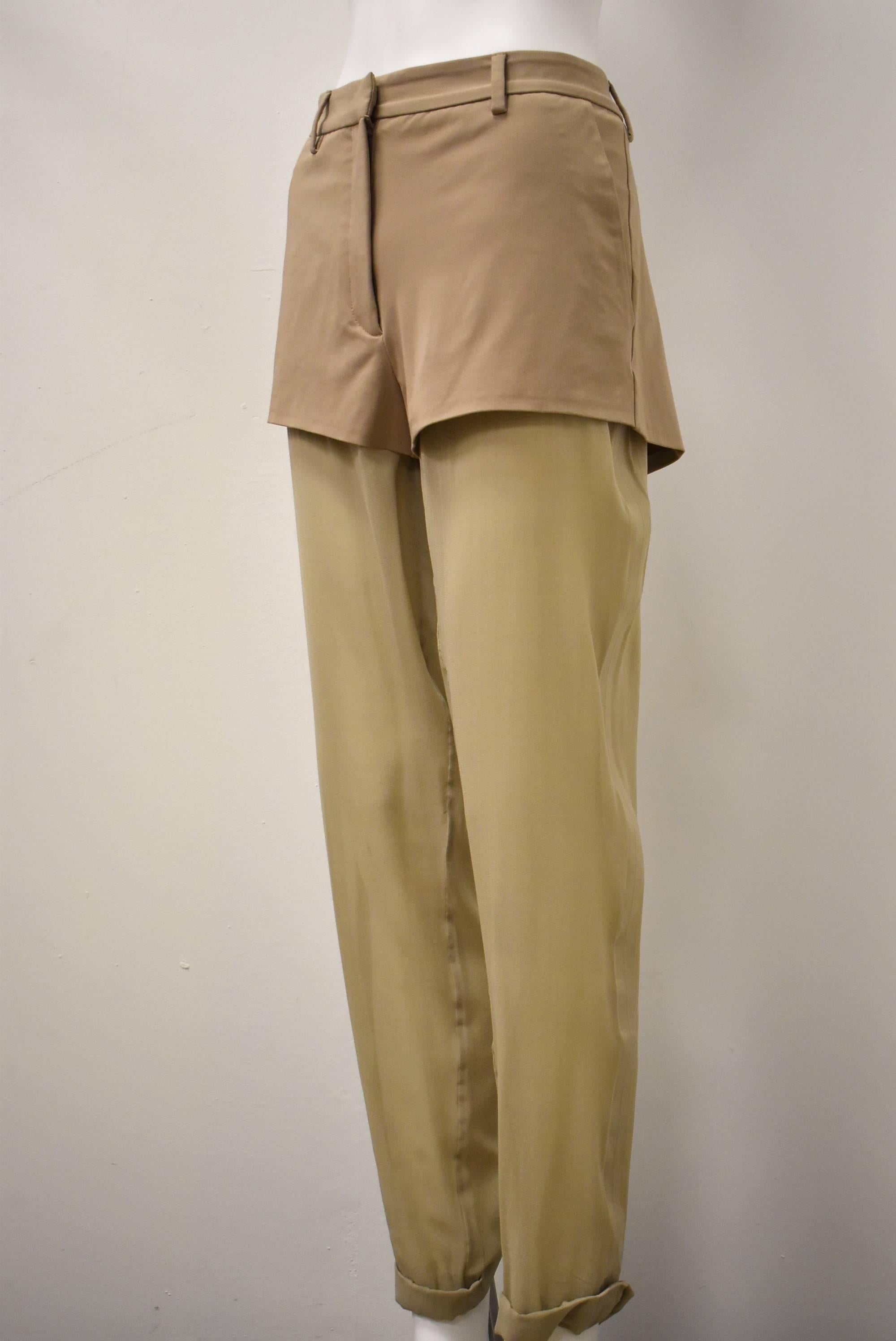 A pair of unusual and unique shorts/ trousers from Maison Martin Margiela Line 1. The shorts are a camel/beige colour with attached sheer trousers in a similar beige tone. The sheer trousers reveal the legs beneath in a subtle way, creating a