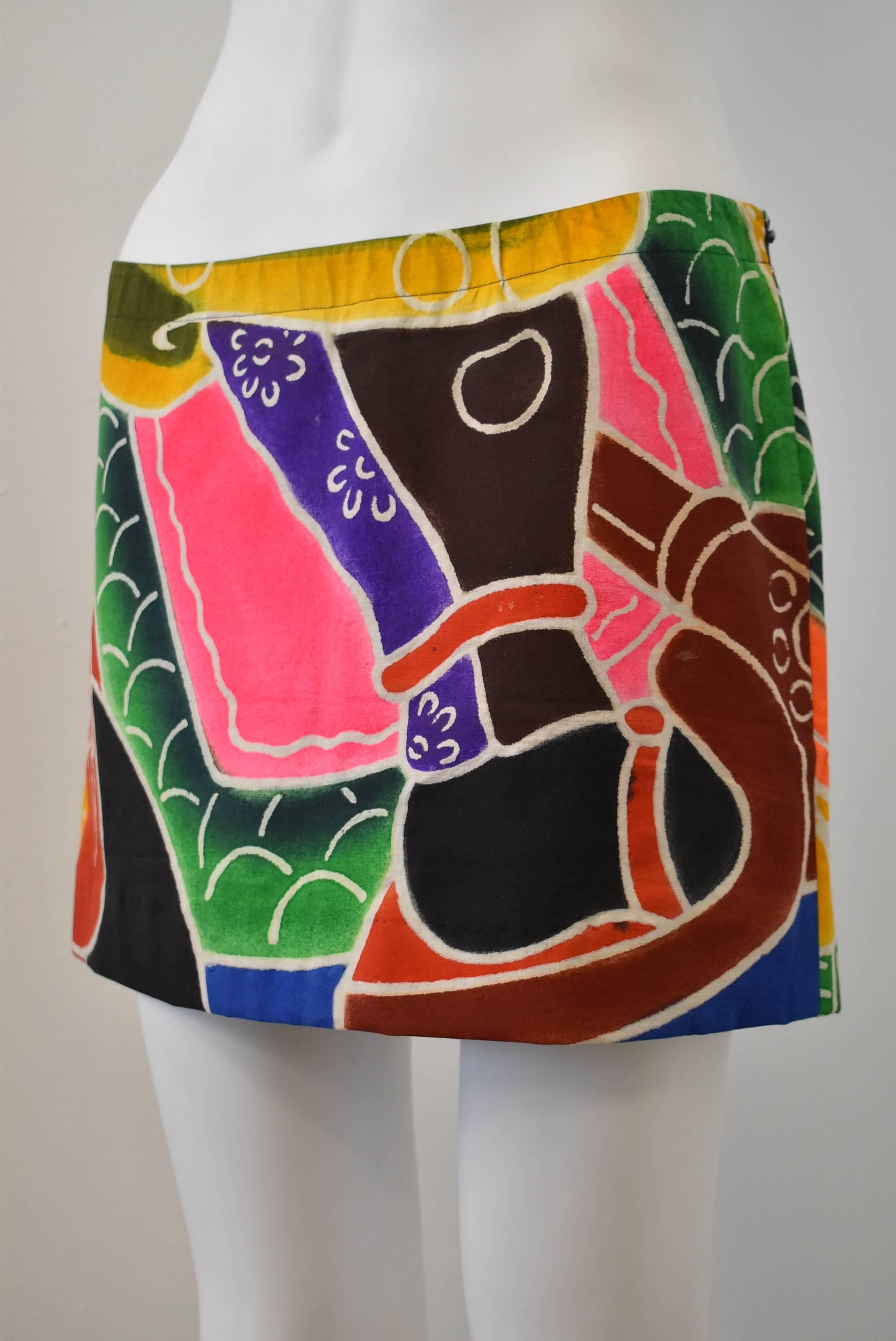 A beautiful and unique hand painted mini skirt from Japanese designer Junko Shimada. The simple mini skirt is made from a traditional hand-painted Japanese festival banner with multi-coloured patterns and shapes. There is a detail of a samurai’s leg
