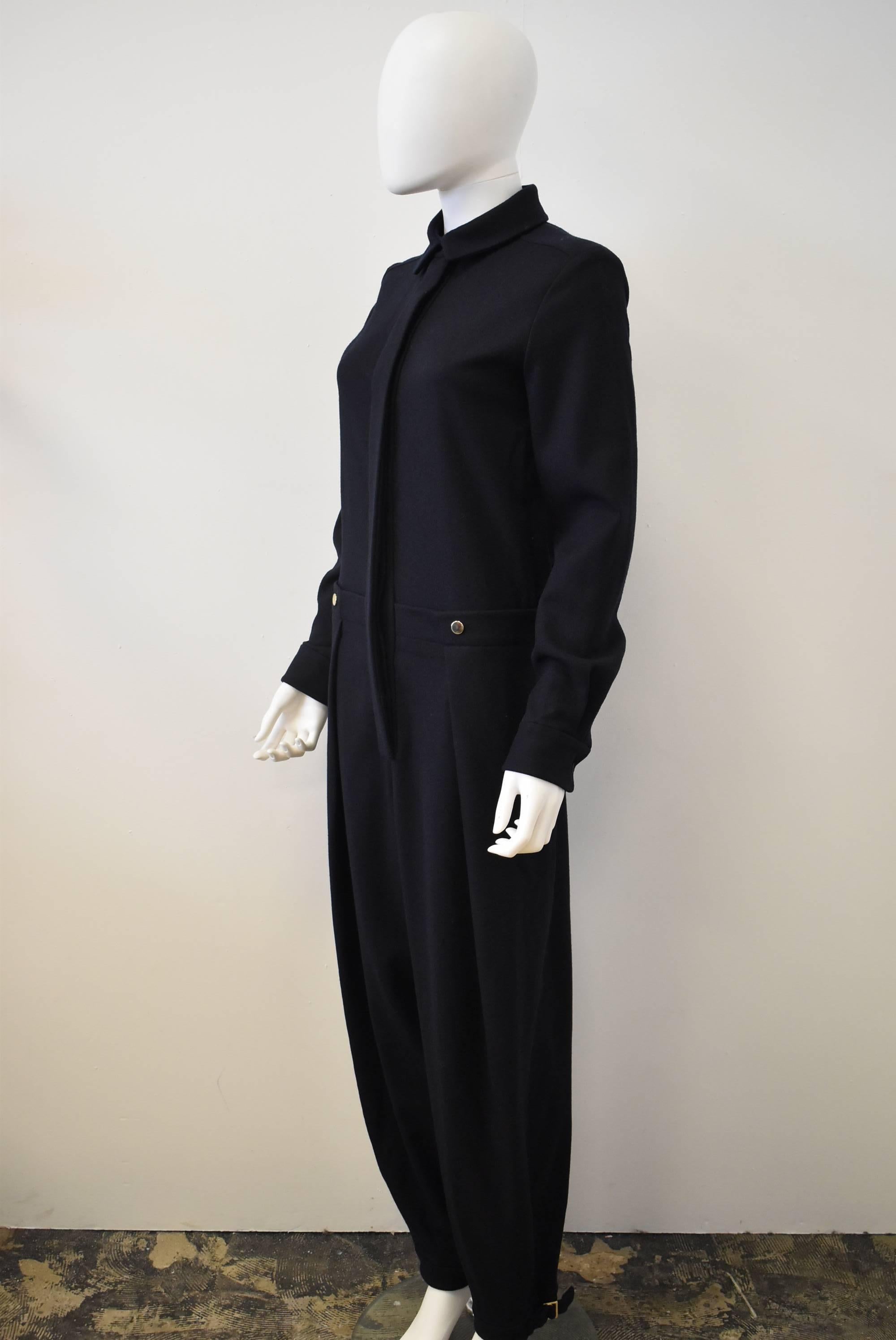 A beautiful tailored navy jumpsuit by French fashion label Chloe. The jumpsuit has a button-front closure, collar, pleated trousers and cinched ankle cuffs. The back has tuxedo trouser details with buttons, and belt. 