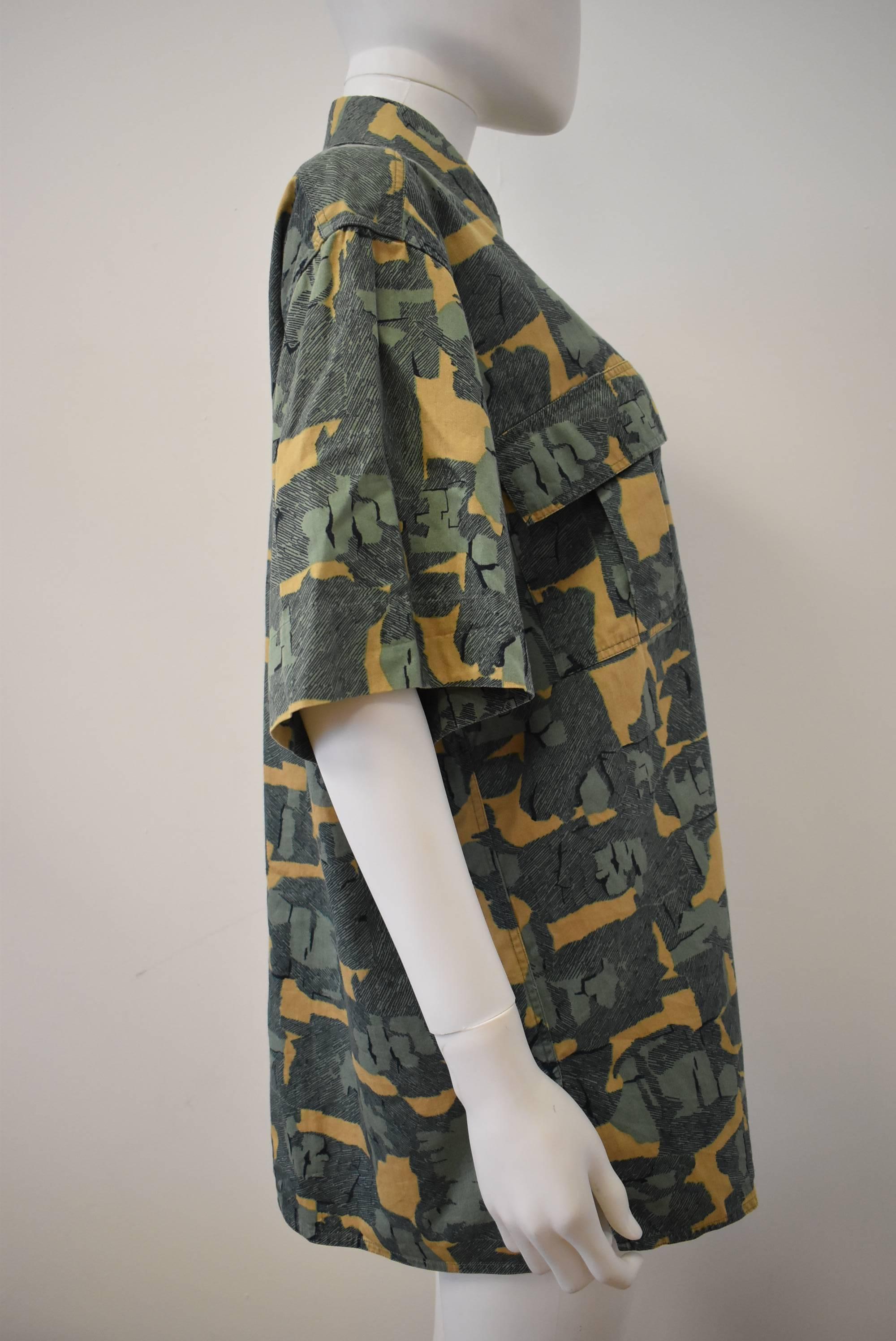 A green abstract print shirt from Azzedine Alaia. The shirt features a yellow, green and navy print. The shirt is cut in Alaias signature 80s boxy style fit and has two utility pleated front pockets. 

Shoulder -20
Collar - 4
Sleeve - 10
