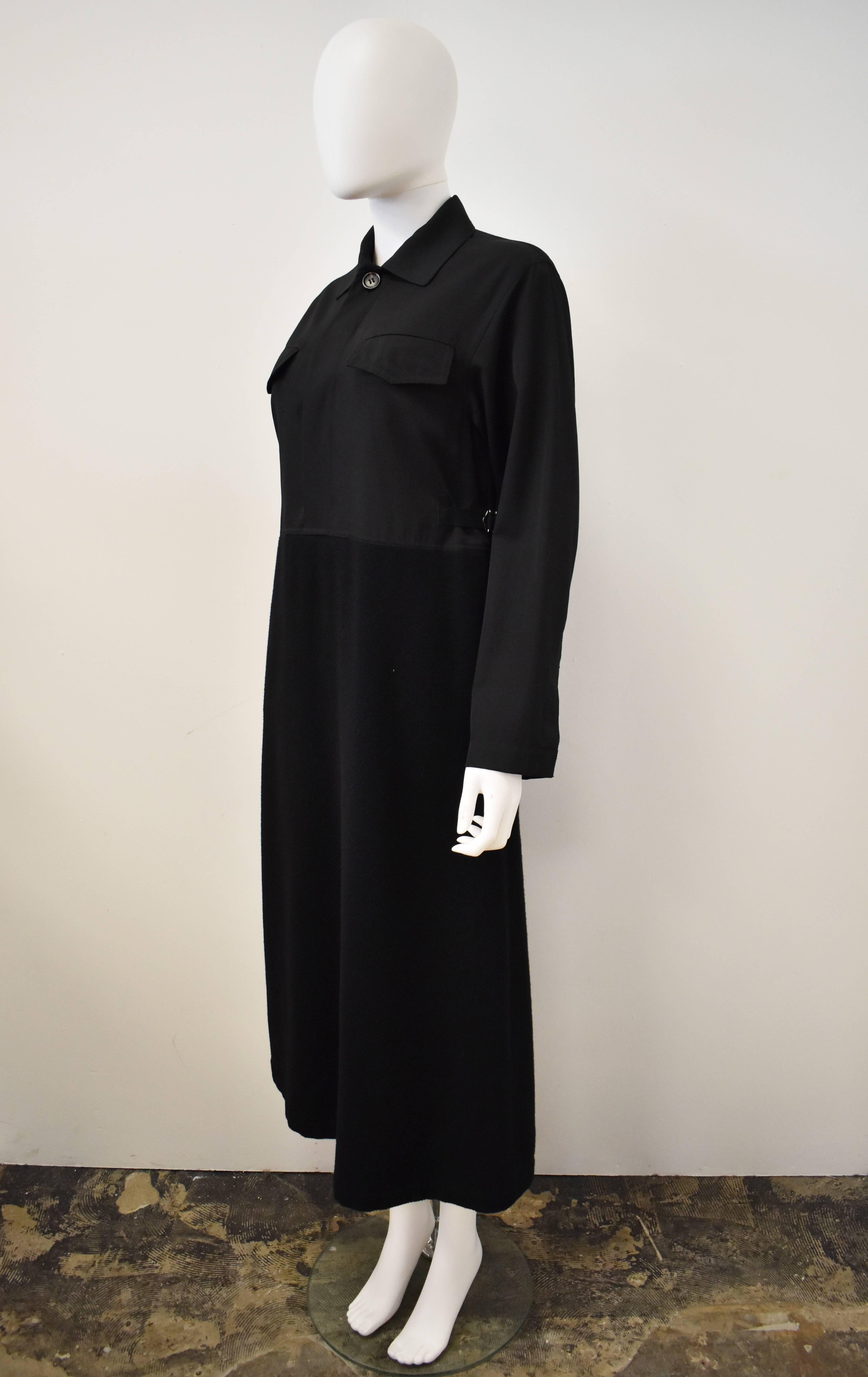 Comme des Garcons Black Tricot Dress with shirt top and wool skirt. The long-sleeve dress has a shirt design top made of a thinner cotton/wool blend and has a contrast thick wool skirt. It has buttons at the neckline and D-ring fasteners at the