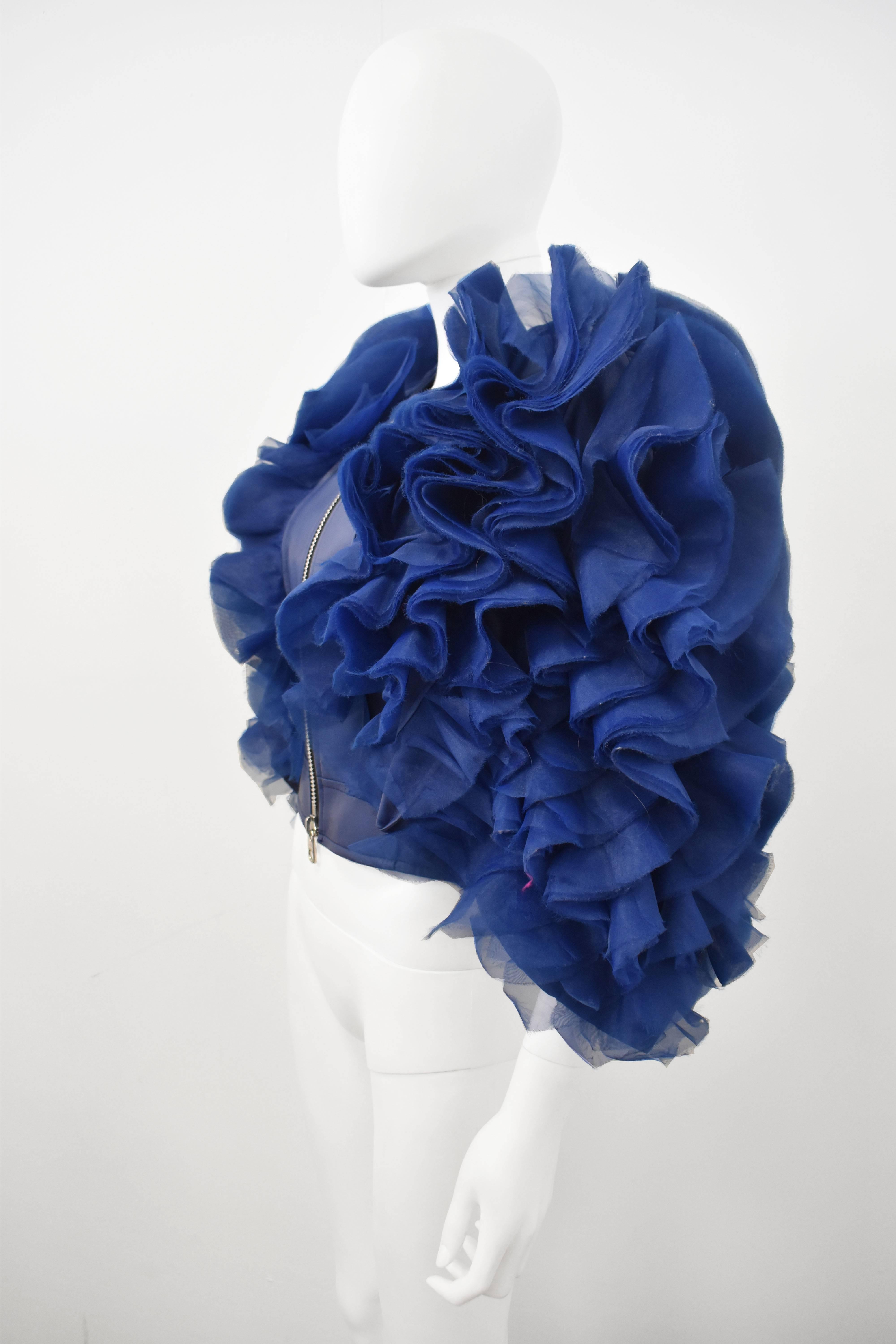 Bright blue faux leather biker jacket with layered organza ruffles by Junya Watanabe from the Spring 2012 ready-to-wear collection. Zip closure and side buckles. Fully lined. In excellent condition. 
