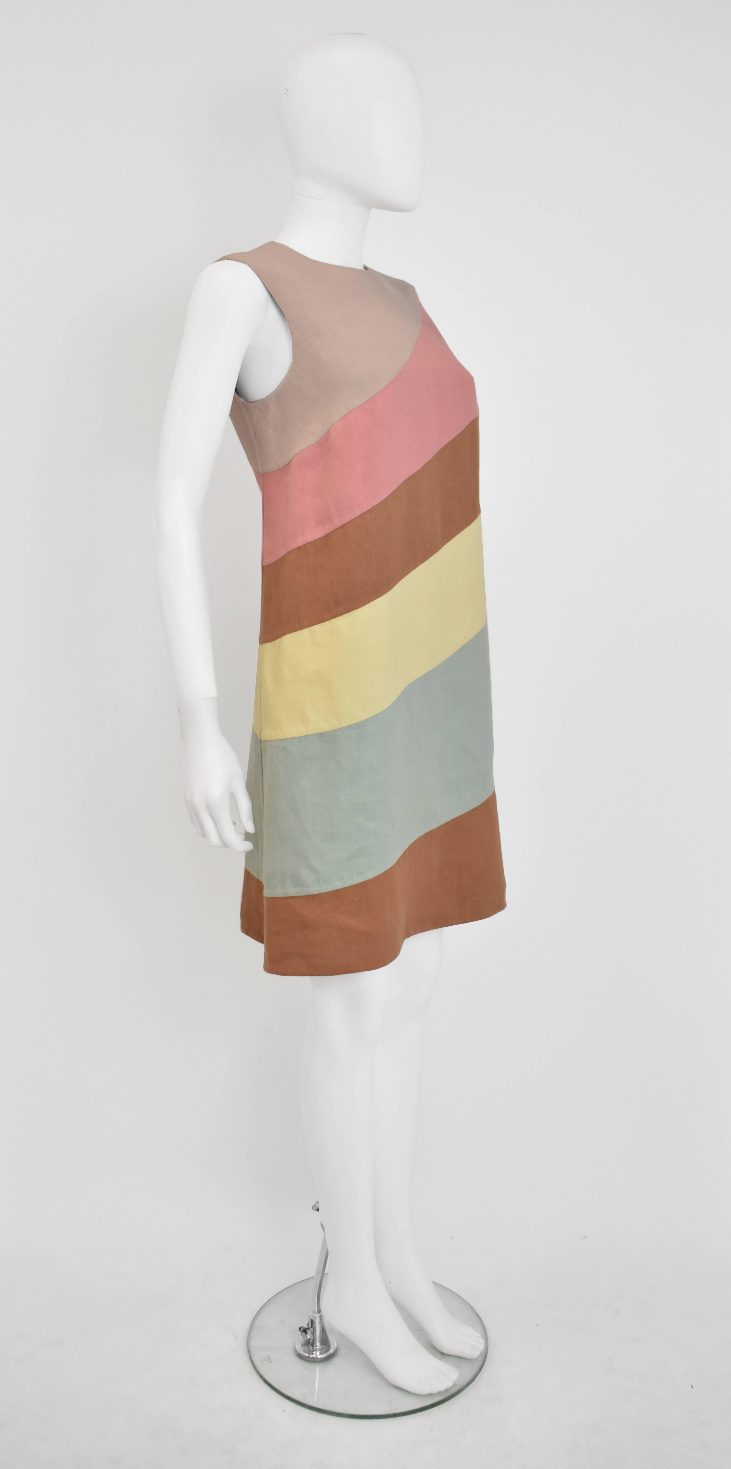A light and Summery linen dress by Valentino. The dress has a simple, sleeveless, A-line shift shape that falls just above the knees. The dress is made from concentric layers of pastel coloured linen in diagonal stripes. It is in excellent condition