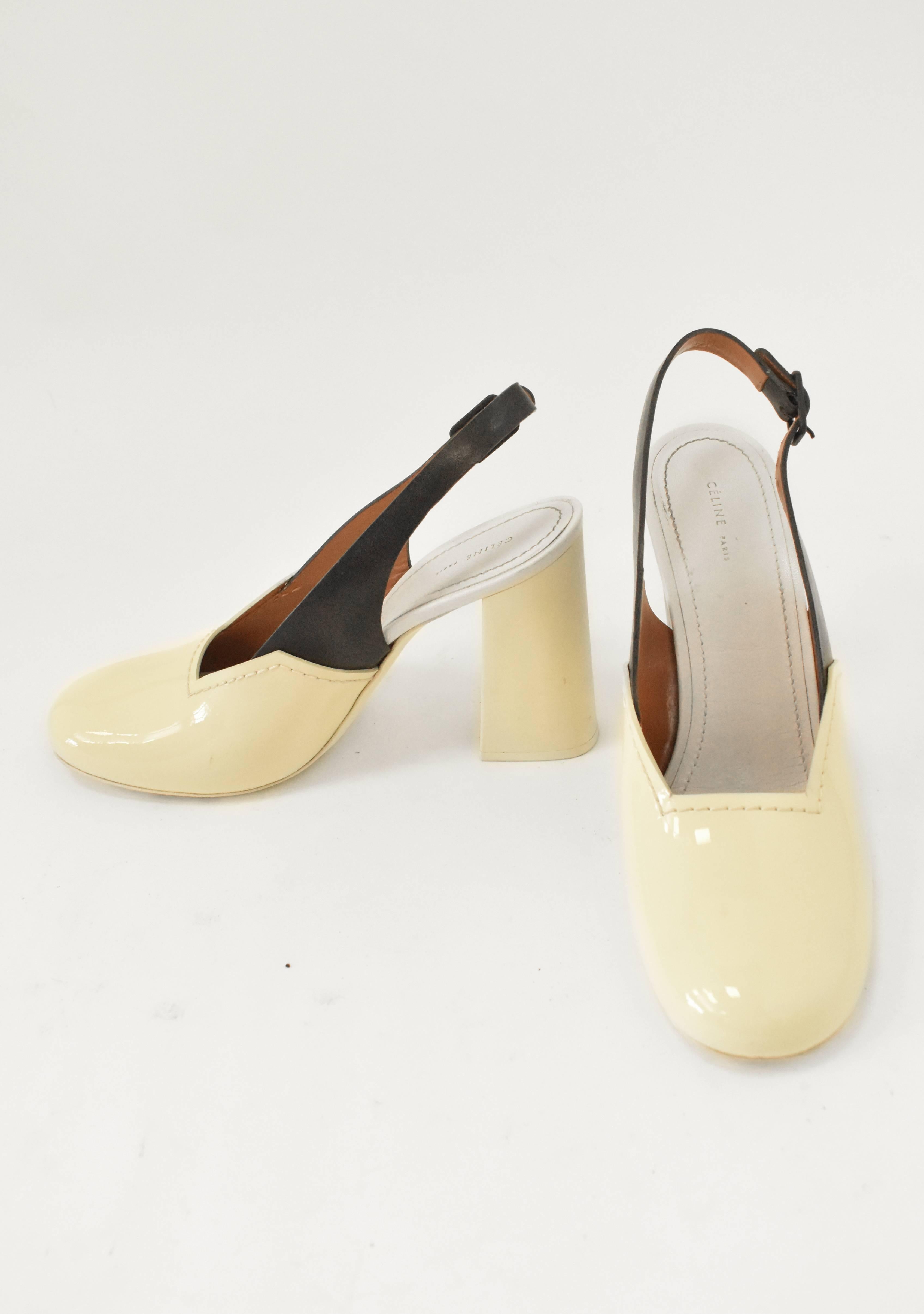 A pair of elegant and modern heels from Celine. The round toe shoes are made from cream patent leather with a contrast black leather slingback strap and buckle. They also feature a chunky 4 inch heel made from rubber giving the shoes an interesting