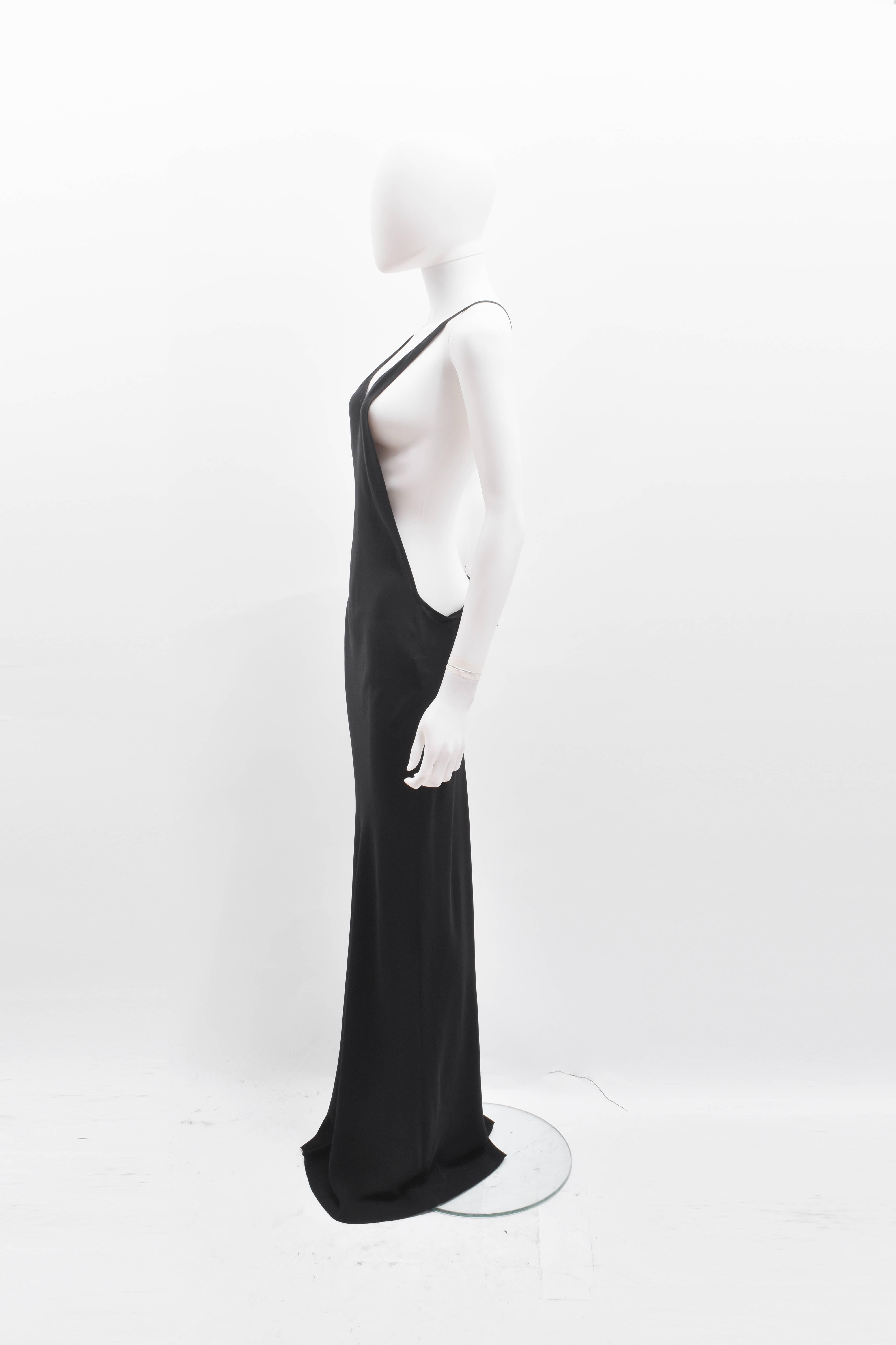 A beautiful and elegant black floor length silk dress from Belgian designer Ann Demeulemeester. The dress has a long and slim shape that skims the body, with strappy racerback shoulder straps and a low neckline. From the back, the dress also has an