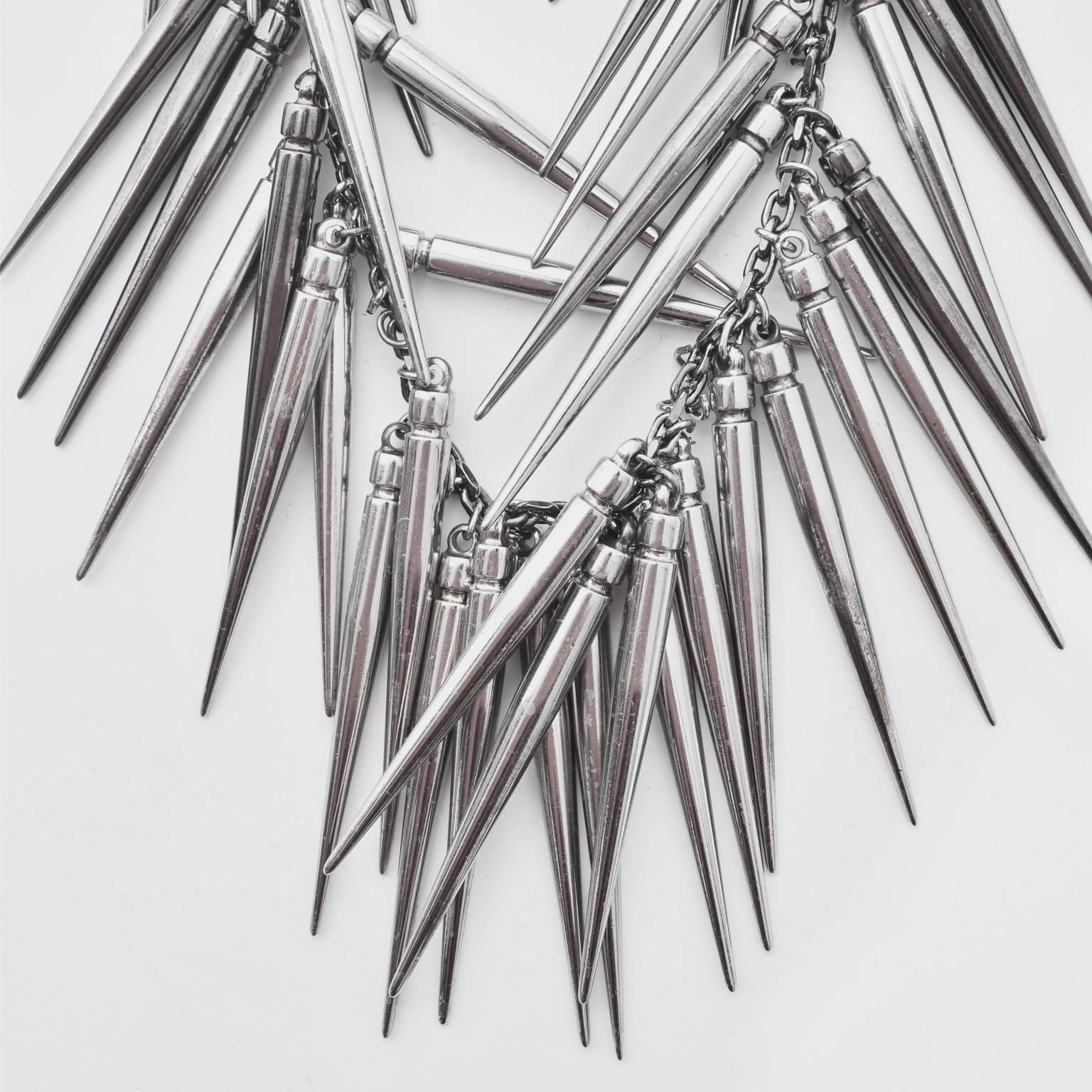 A stunning large statement necklace from Burberry’s 2010 Prorsum runway collection. The necklace is made from gunmetal spikes on a silver chunky chain that circle around the entire necklace. It is heavy and certainly makes a bold statement.
The