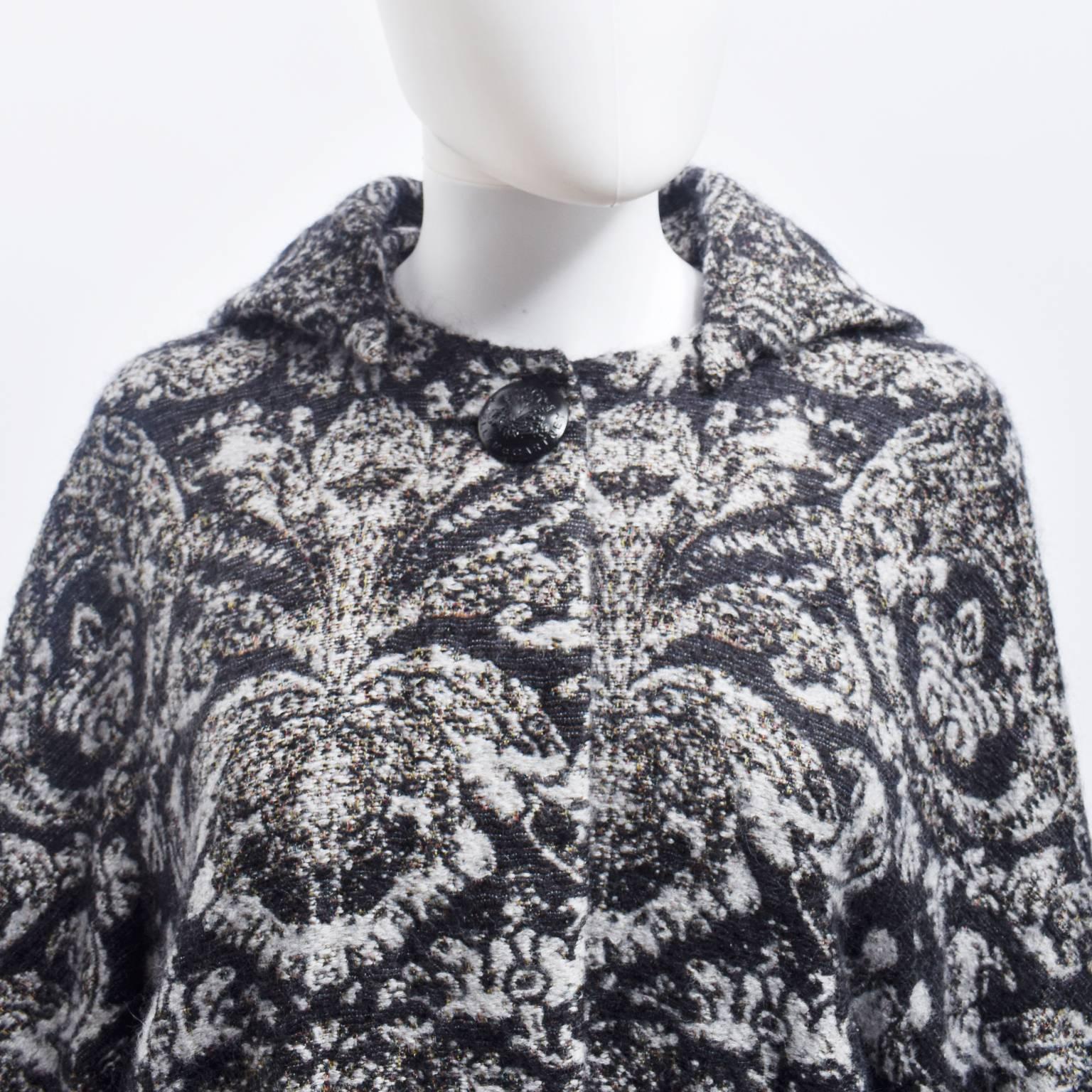 A beautiful brocade cocoon coat from British designer Stella McCartney. The coat has a beautiful oversized shape that has a soft, round shape. In contrast to this, the sleeves have an unusual, geometric shape; a modern twist on a Kimono sleeve. It