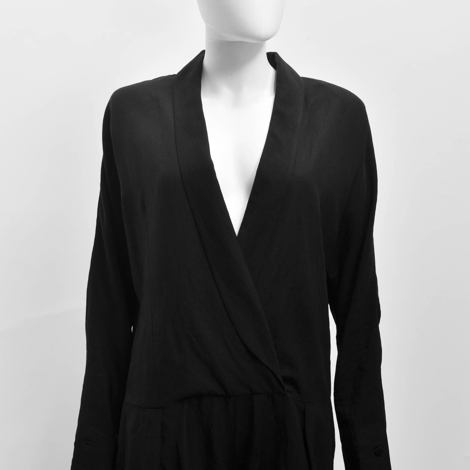 A classic black tuxedo jumpsuit from French designer Isabel Marant. The jumpsuit has long sleeves, a crossover V-neck opening with lapels, dropped waist and relaxed trouser shape. The construction of the sleeves is unusual, with a slim forearm that