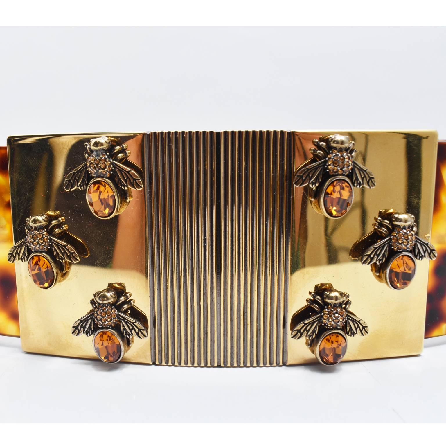A stunning and extremely rare perspex belt from Alexander McQueen’s Spring/Summer 2013 runway collection. The waist belt is made from a circular piece of tortoiseshell perspex with a gold plated clasp at the front decorated with golden bees and