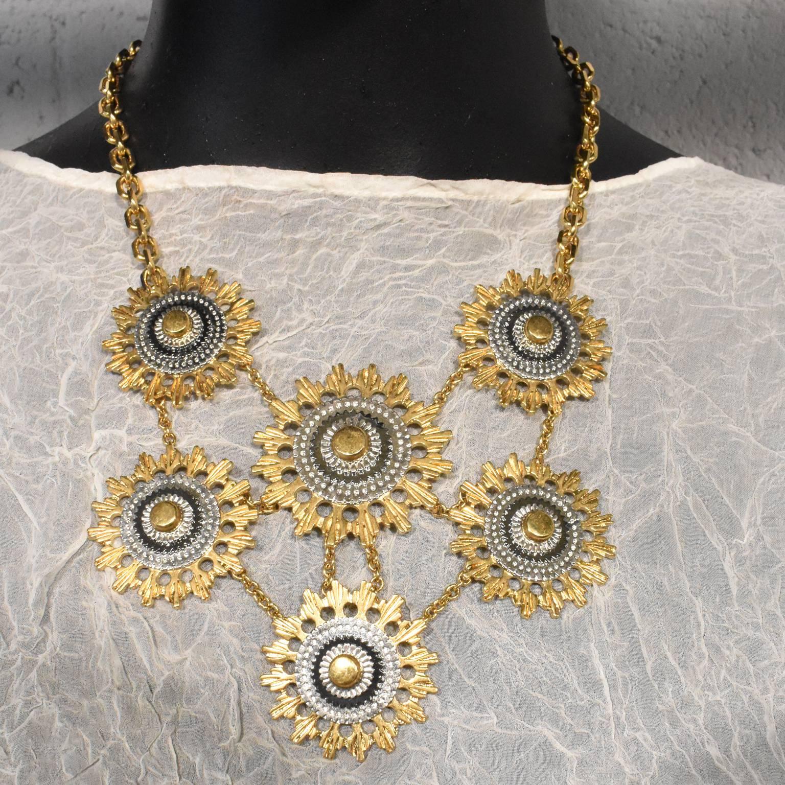 A stunning gold plated necklace from Alexander McQueen. The necklace is constructed from six abstract, mechanical sunbursts attached via gold chain. The pendants are attached to a chunky gold chain with a hook and two jump rings to adjust for