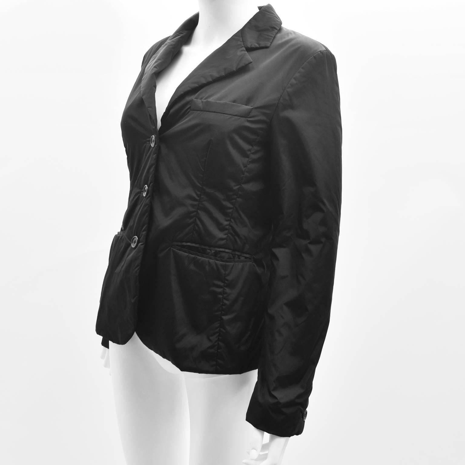 A sporty black nylon padded blazer from Prada’s sport collection. The blazer has a classic design, with cropped shape, collar and long sleeves but is given a sportswear twist with the padded tech/nylon fabric. The jacket is in excellent condition