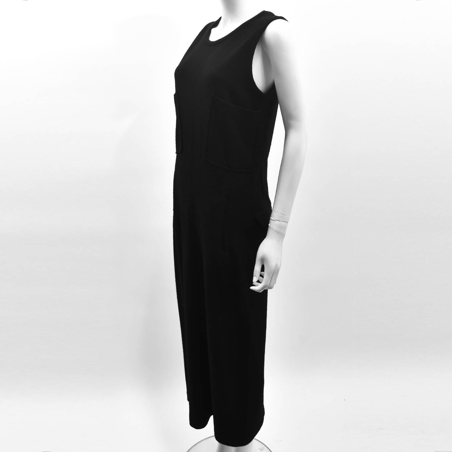 A stunning and versatile long black sleeveless dress from Y’s by Yohji Yamamoto. The dress has a simple, sheath shape with round neckline and sleeveless cut. It also features four pockets, adding a utilitarian and modern twist to a simple design.