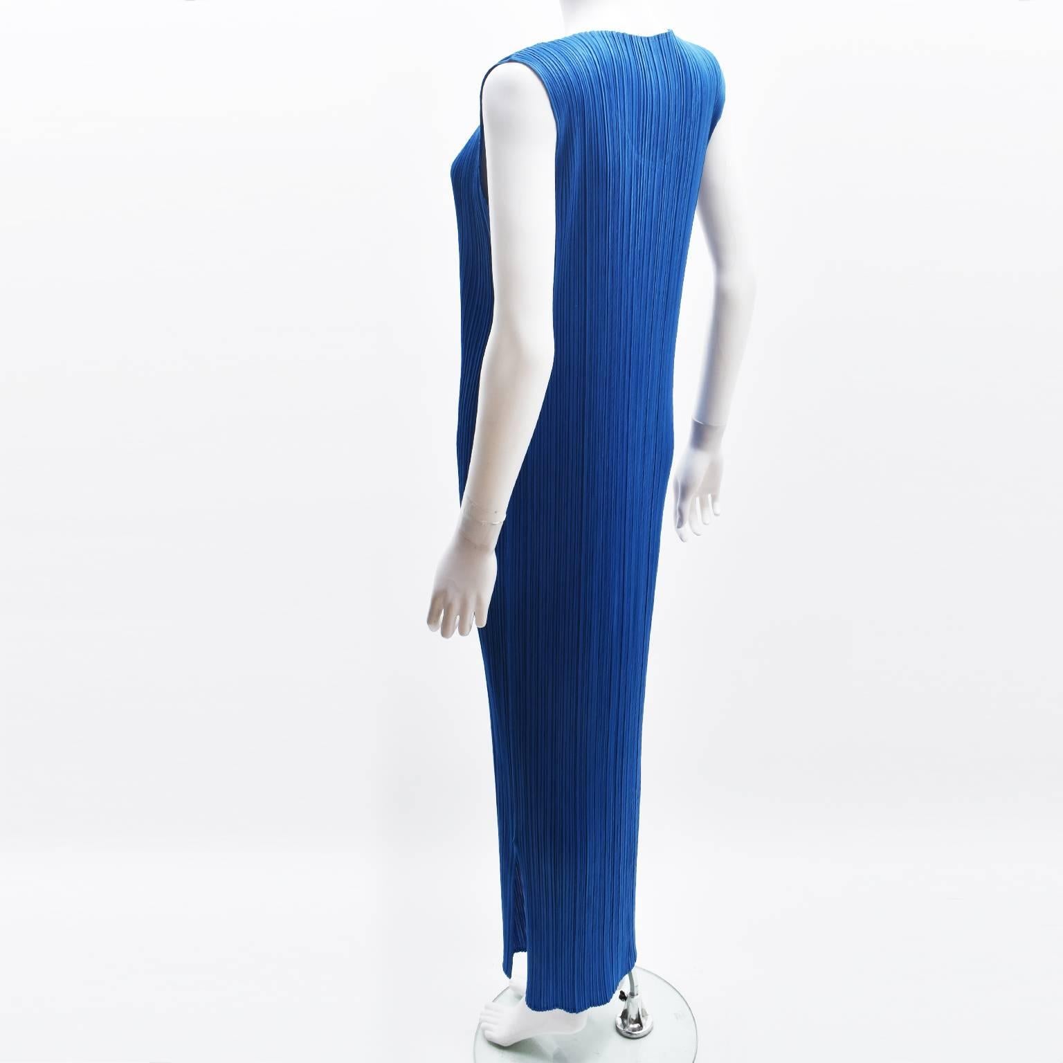 A stunning and bright electric blue pleated dress from Issey Miyake's PLEATS PLEASE line. The dress has a very simple long shape that falls just above the ankle, straight shape, sleeveless cut and round neckline. It is made from Miyake's signature