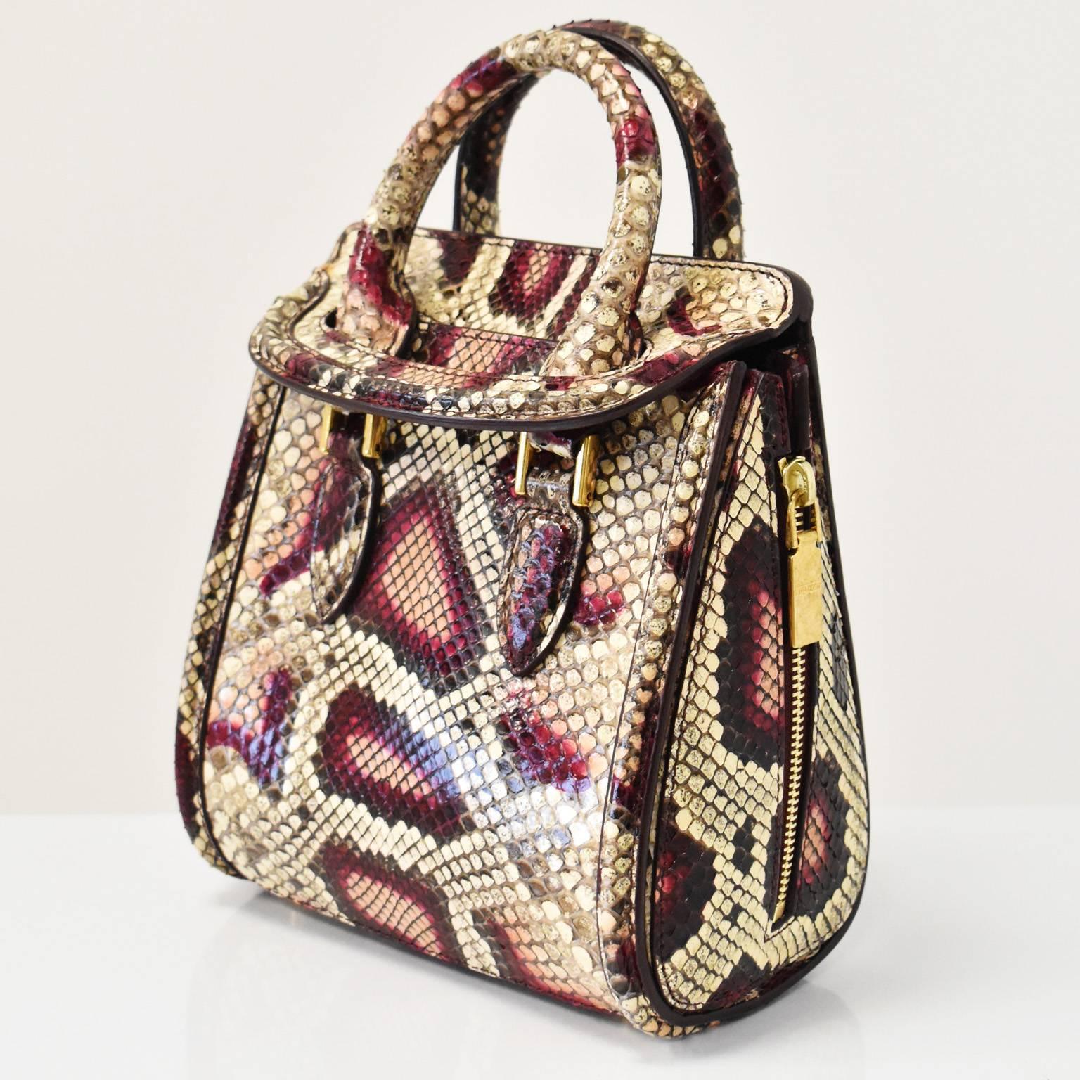 A beautiful and luxurious snakeskin ‘Heroine’ handbag by Alexander McQueen. The mini ‘Heroine’ bag has a teardrop shape with an unusual flap fastening that the top handle goes through for security. It also has a detachable shoulder strap, side zip