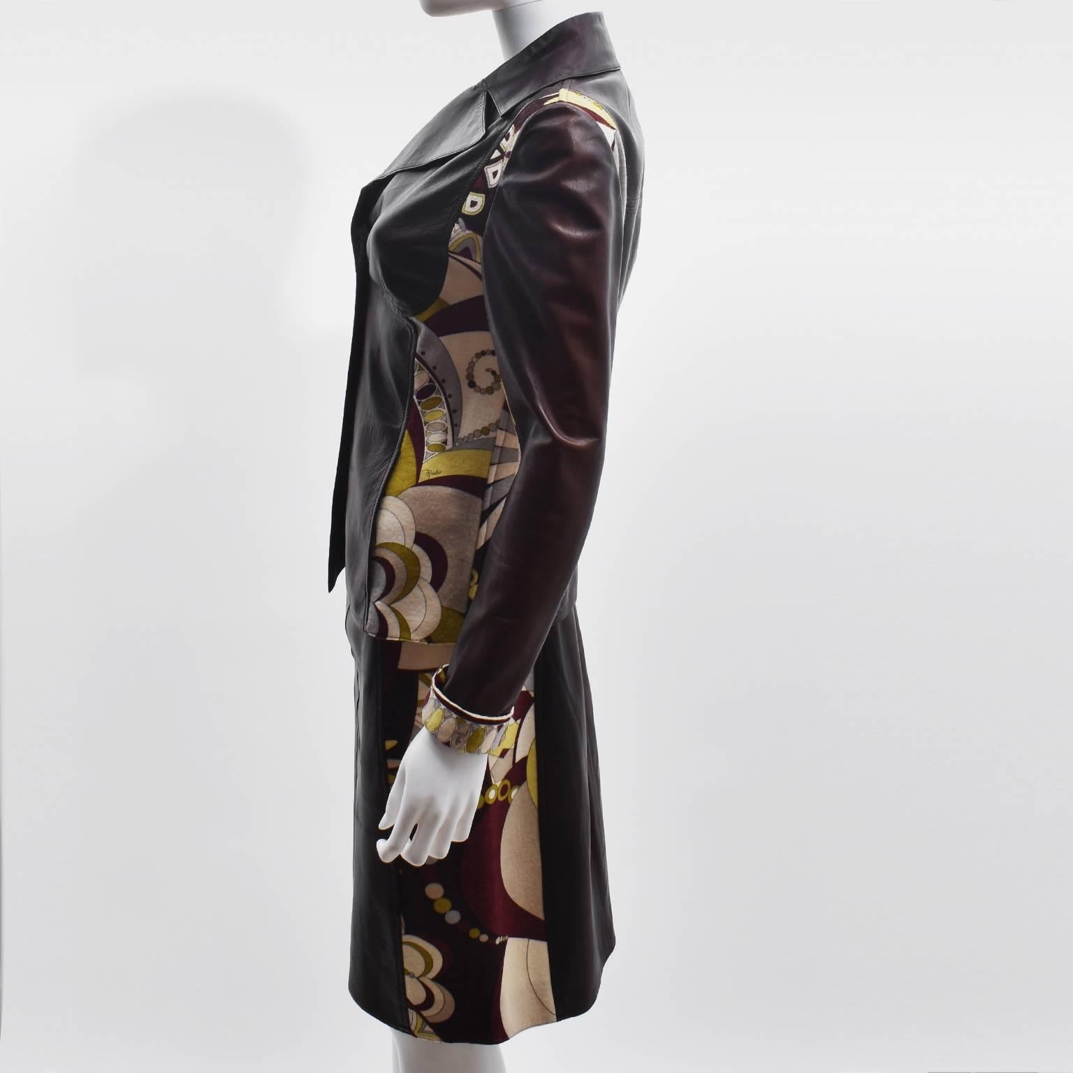 A stunning Emilio Pucci jacket and skirt two piece suit. The jacket and skirt is made from a combination of reddish brown lamb leather and wool in Pucci’s iconic psychedelic print that forms the side panels and front details. The jacket has a slim