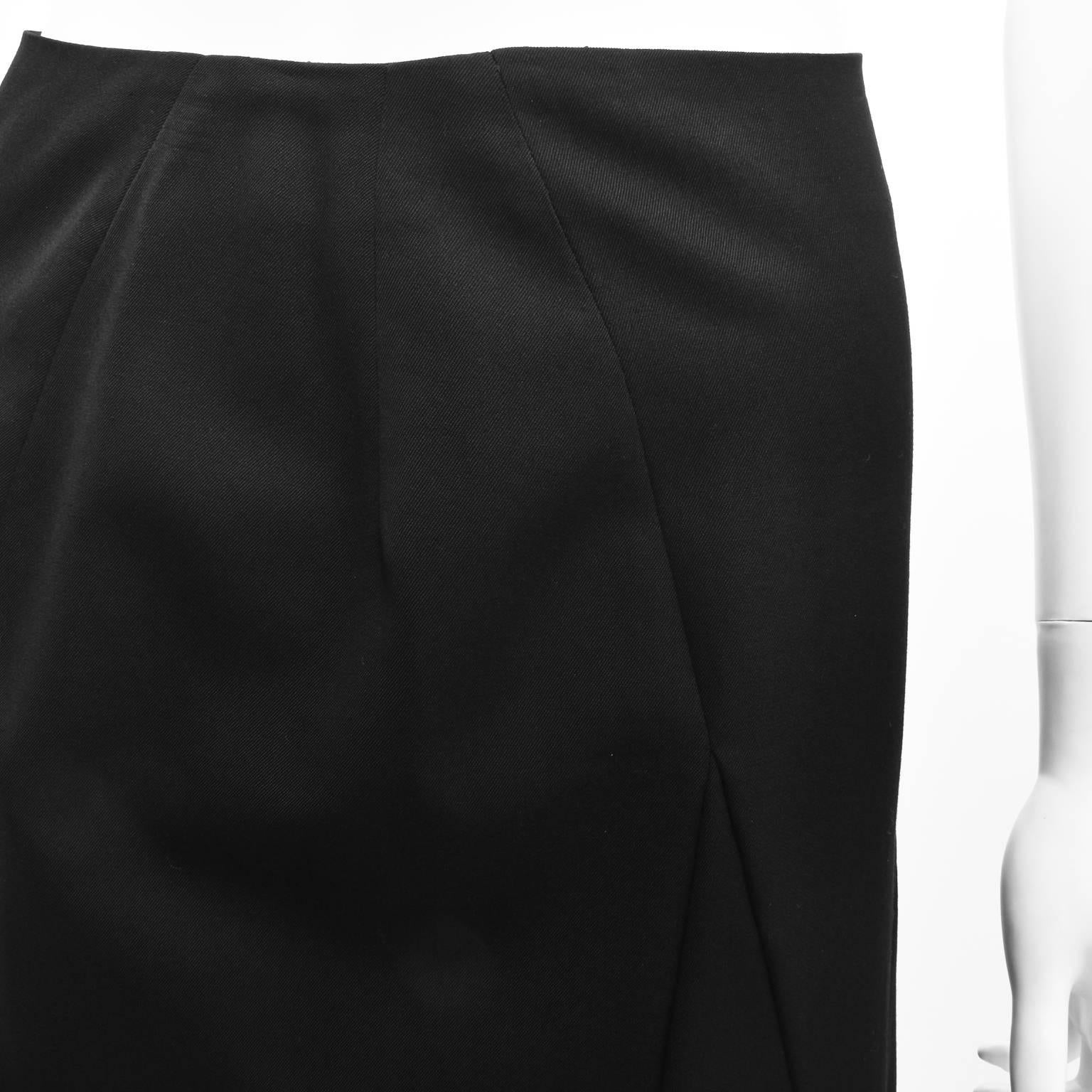 A long black high-waisted skirt from Yohji Yamamoto Noir featuring an A-line shape and several asymmetrical wool panels to the front, a zip fastening to the back. A Japanese size 2 (small to extra small), it is in excellent condition. 

