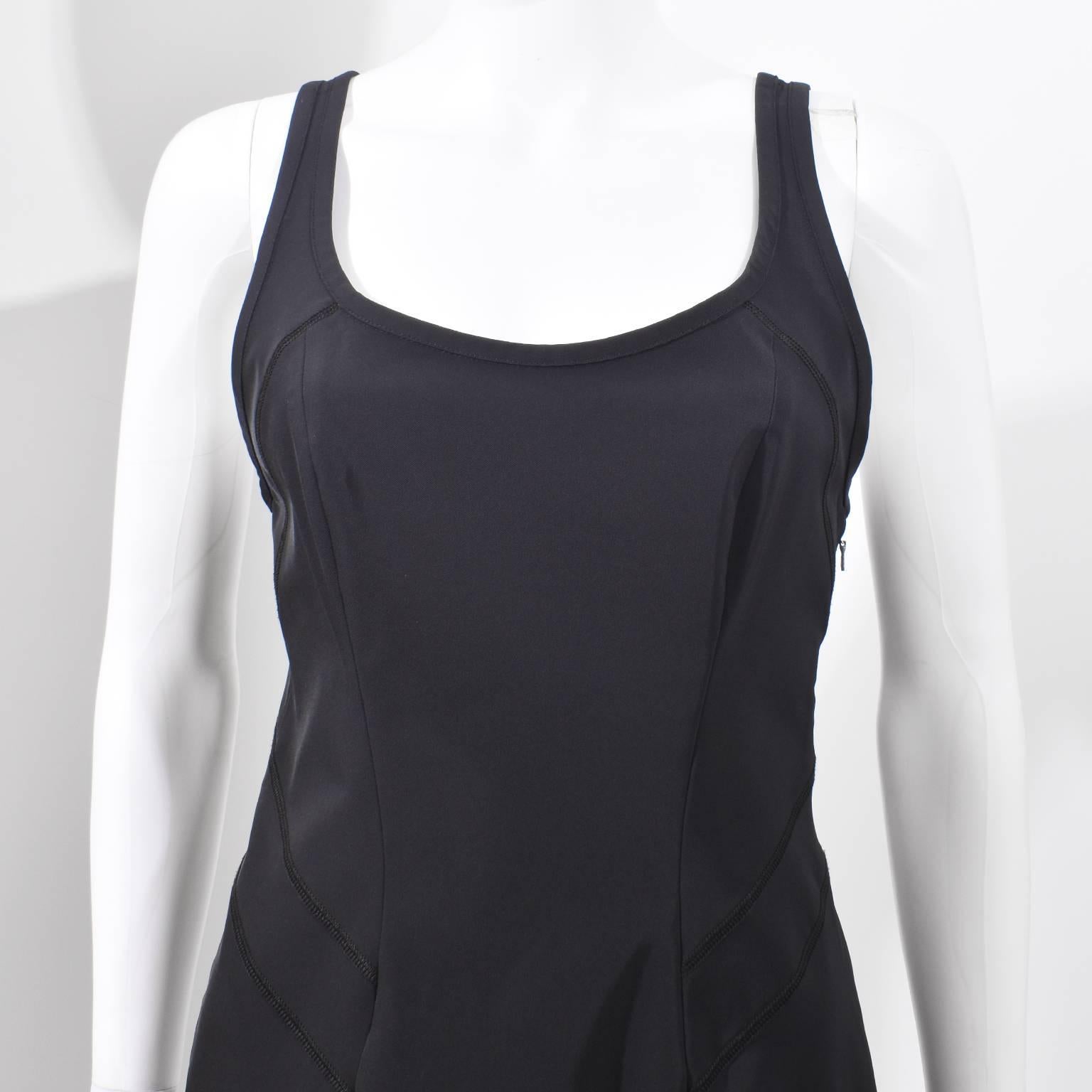 A beautiful 1990’s black Prada Sport racerback sleeveless dress. The dress has a classic 90’s shape with thin shoulder straps, moulded shape in the bust, fitted waist and bodycon silhouette. It is made from a sporty material, most likely nylon, that