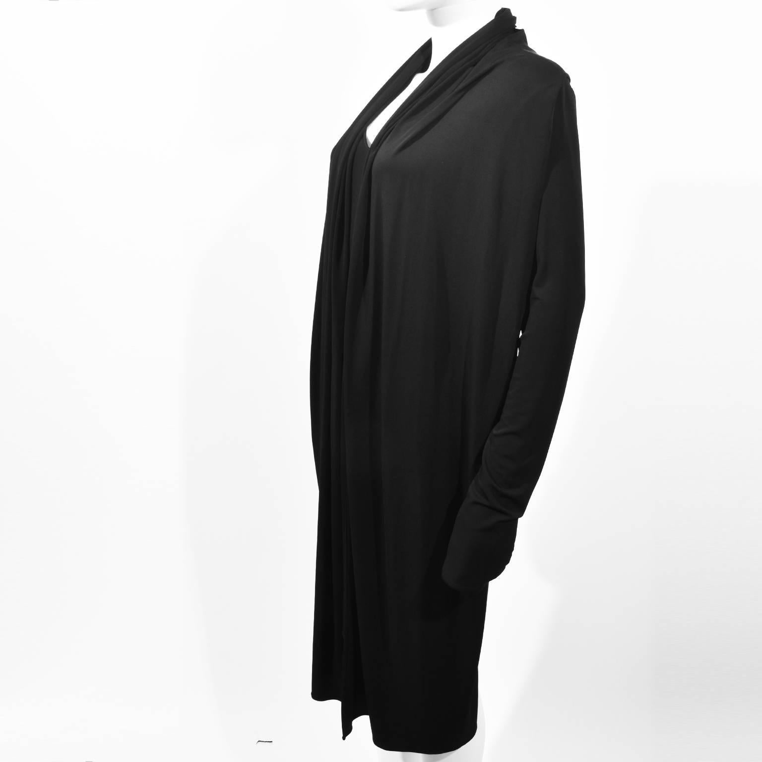 A black loose-fitting viscose dress by Maison Martin Margiela featuring an attached waistcoat with a shawl-like collar. An Italian 46 (UK 14), it is in excellent condition.