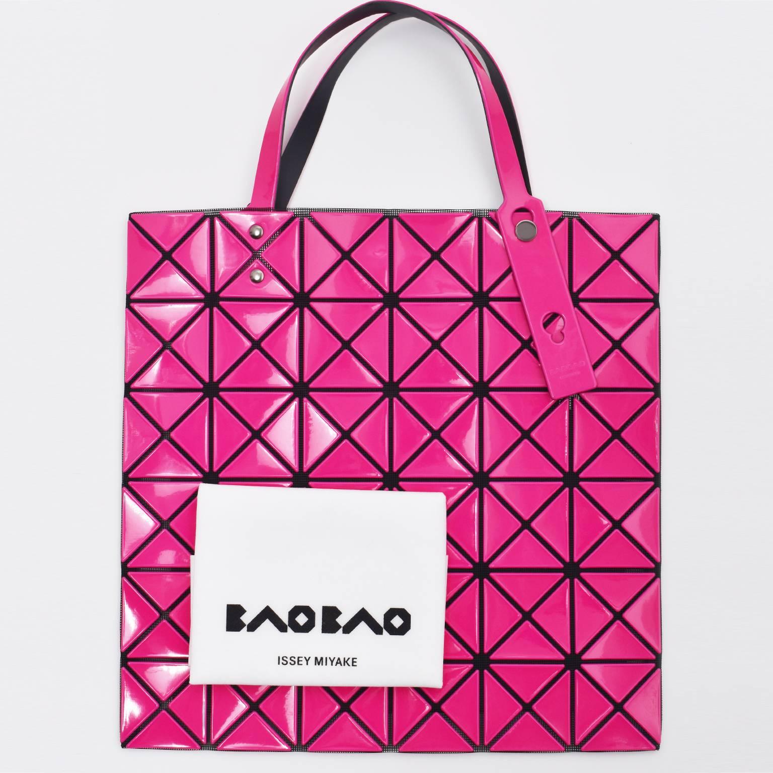 A pink geometric tote bag from BaoBao Issey Miyake. It features small triangles on mesh interior body, adjustable handles, an internal zipped pocket and an internal logo patch. Brand new, with dust bag.  
 