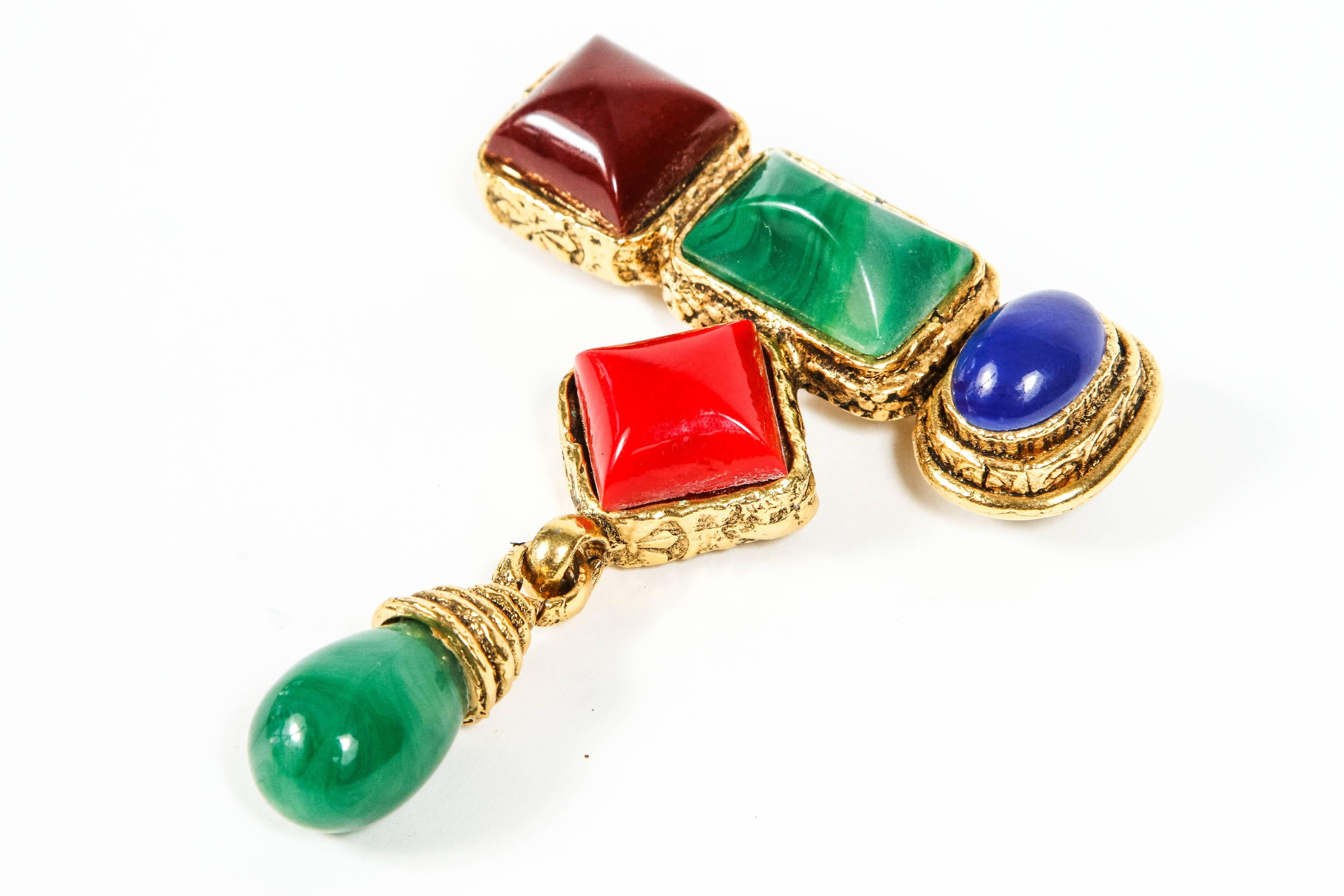 An unusual Brooch with an added pendent element fashioned in gilt metal with wonderful glass stones.  The asymmetrical design adds to the interest. 