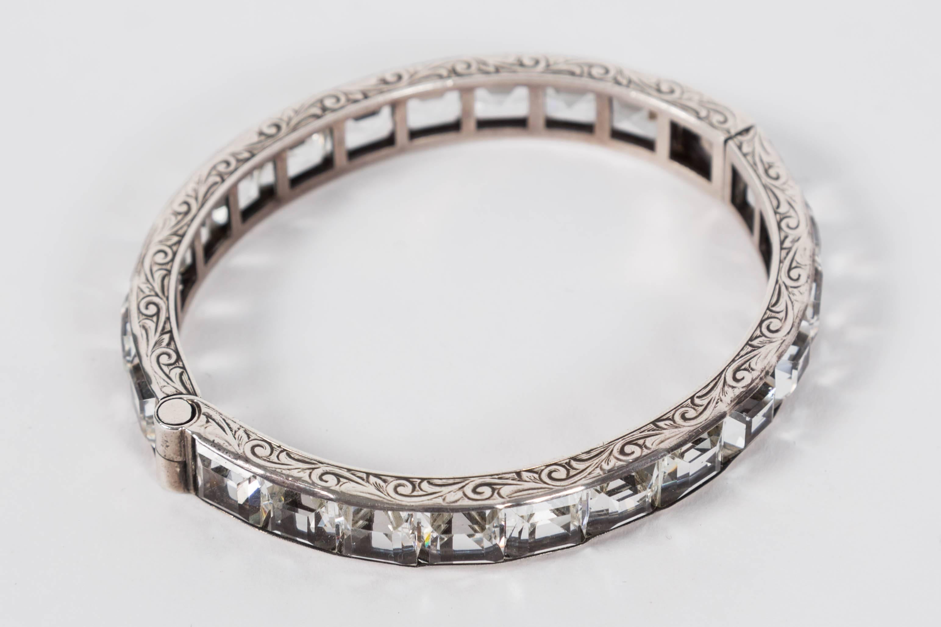 Great Sterling silver and paste bangle.  Features an engraved detail to both top and bottom of bracelet.  Bracelet is hinged and has a clap to one side.
A really lovely piece.