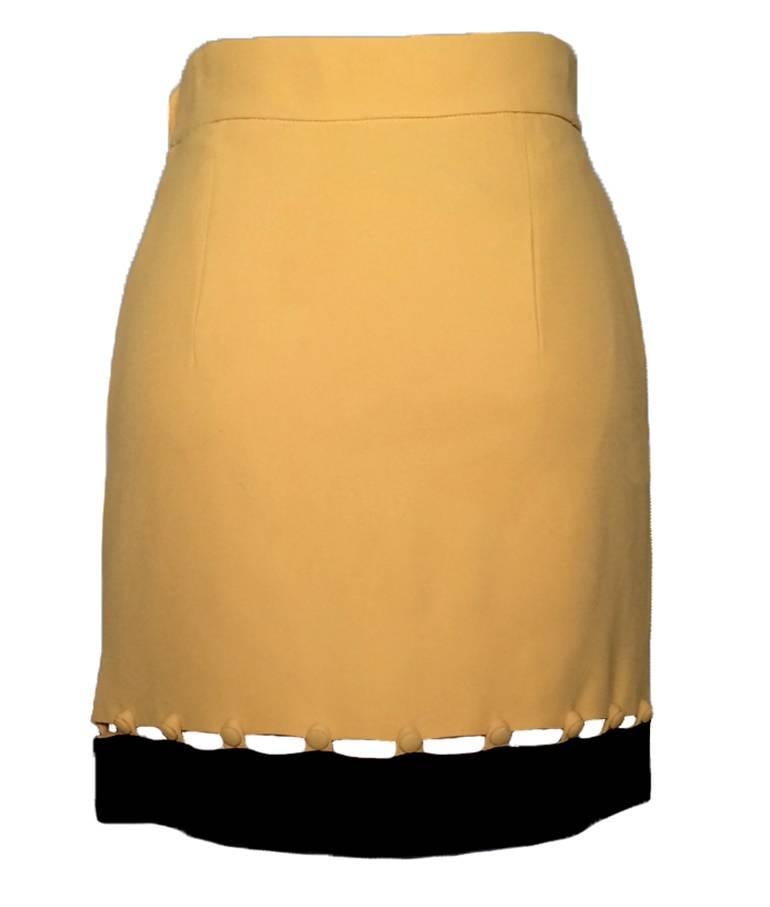 Moschino Cheap and Chic 1990s yellow skirt with black trim attached by small cloth covered buttons. A classic Moschino piece! Side zip and button closure. 

52% rayon, 48% acetate. 
Fully lined in 60% acetate, 40% rayon. 

Made in Italy.

Size IT