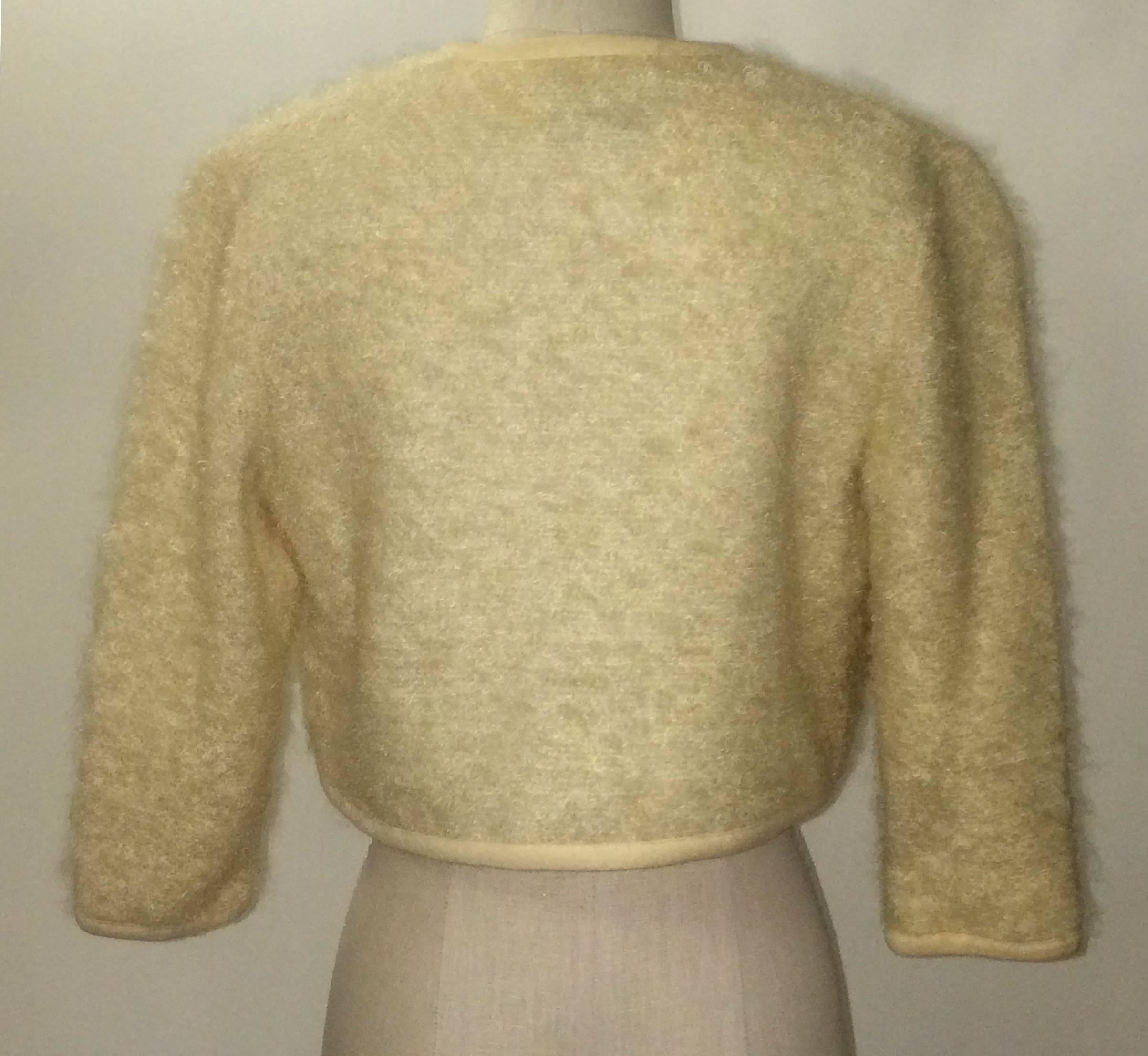 Saks Fifth Avenue (Juniorette Shop) cream fuzzy knit sweater with little pink yarn embroidered flowers throughout front. Fully lined. 

Content unknown. 

No size tag, best fits size XS-S, see measurements (taken open and flat.) 
Bust