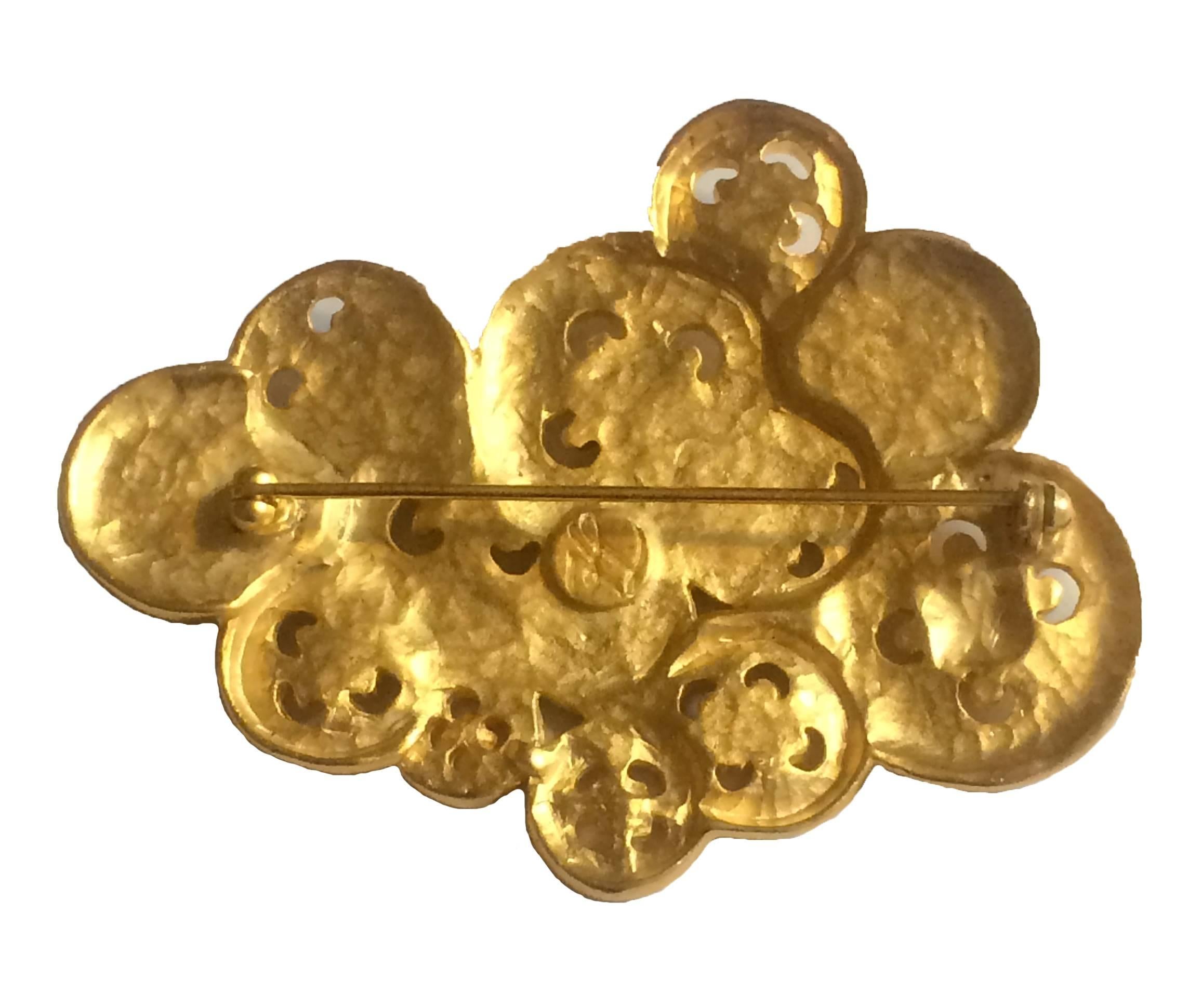 Karl Lagerfeld vintage 1990s gold tone button pin.

Approximately 3 x 2 3/4