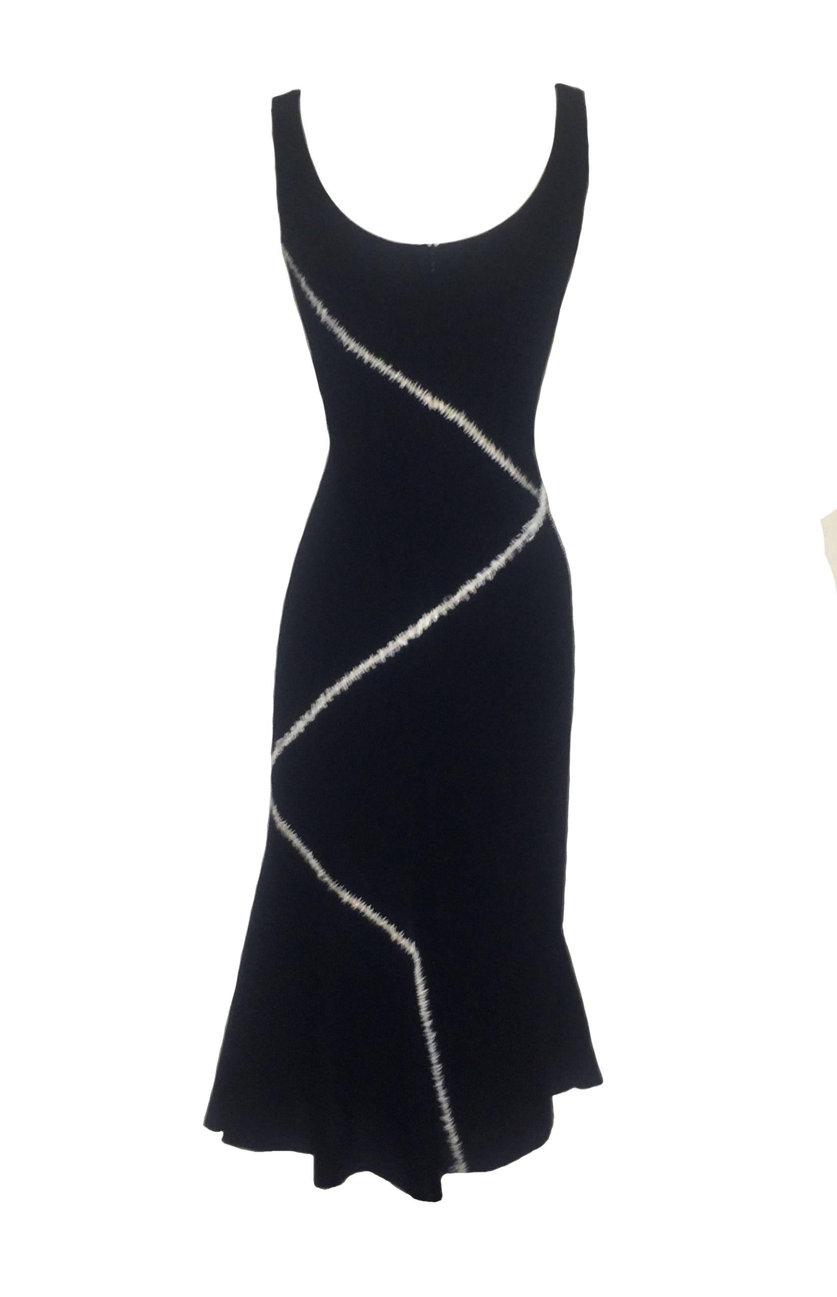 Alexander McQueen 2004 black pieced midi dress with flare bottom. Nude mesh between the panels covered with white stitch detail. Back zip.

81% wool, 17% silk, 1% spandex.
Fully lined in silky fabric.

Made in Italy.

Size IT 40, approximate US